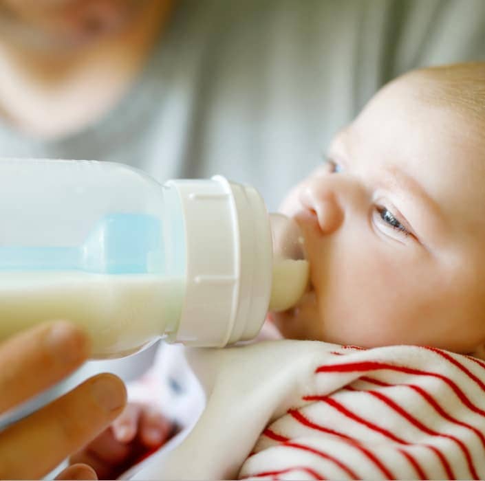 baby drinking from a bottle
