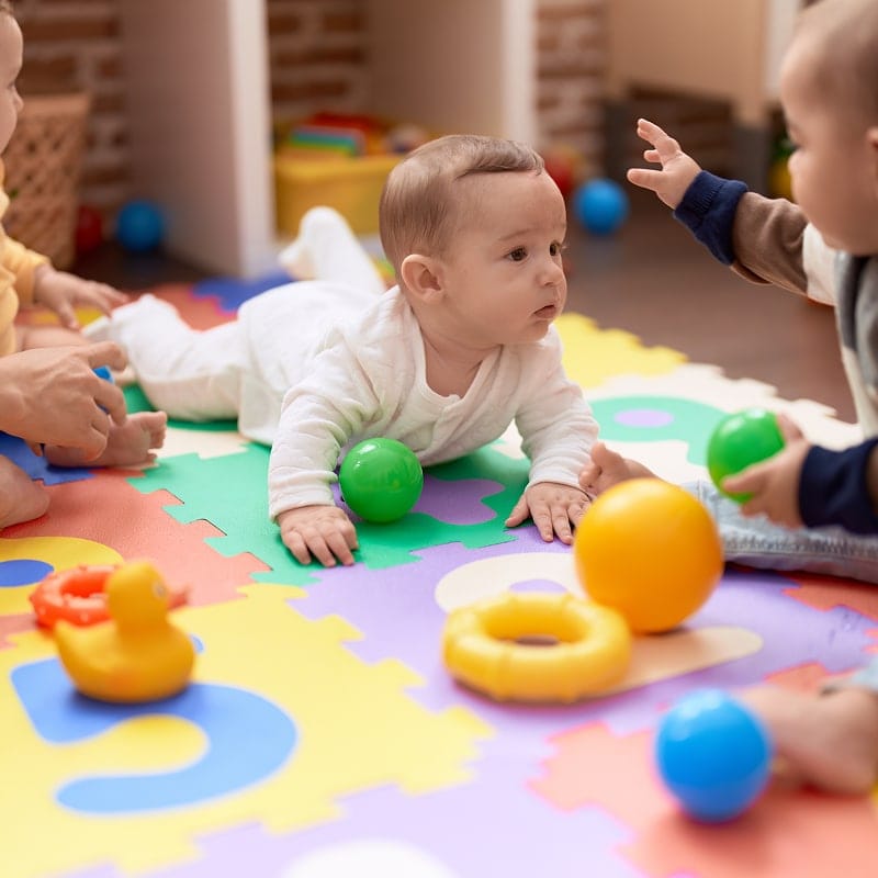 group of babys playing with toys