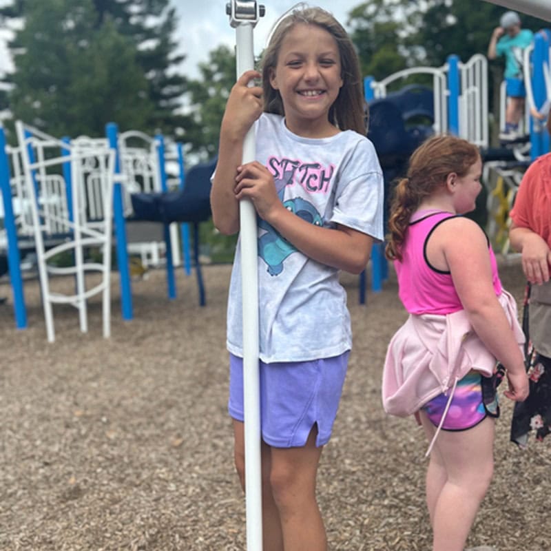 school age girl playing on playground