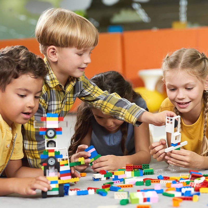 school age kids playing with legos