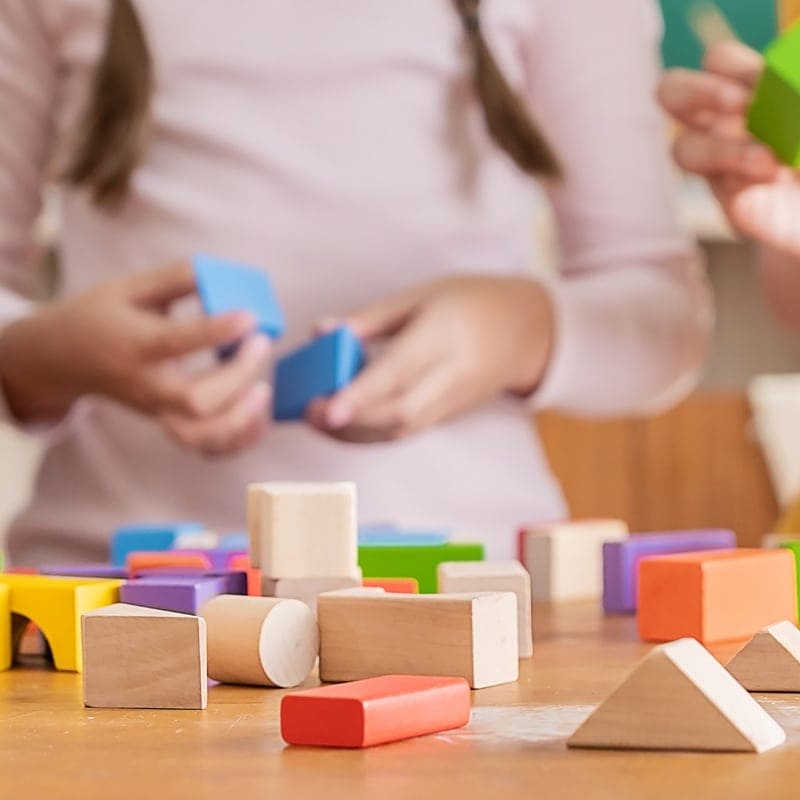 school age students with building blocks