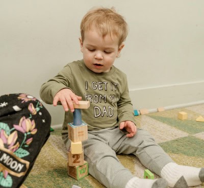 toddler playing with building blocks