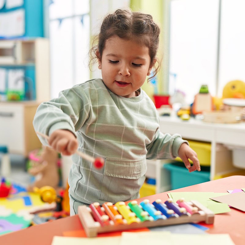 toddler playing with musical instruments