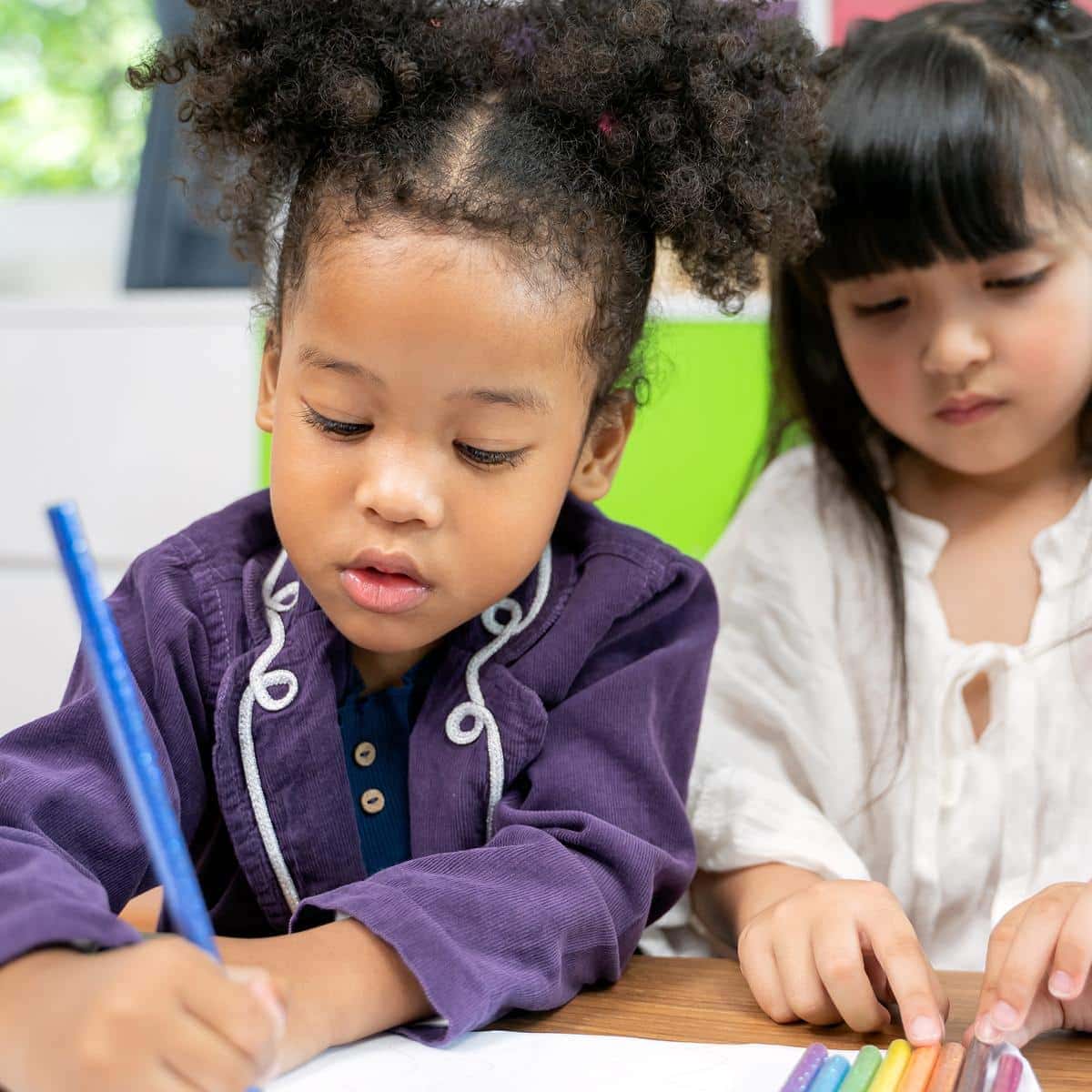 two girls coloring