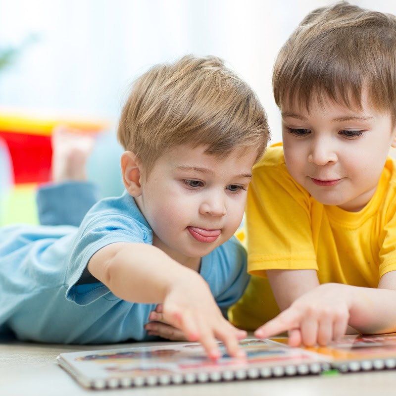 two young boys reading