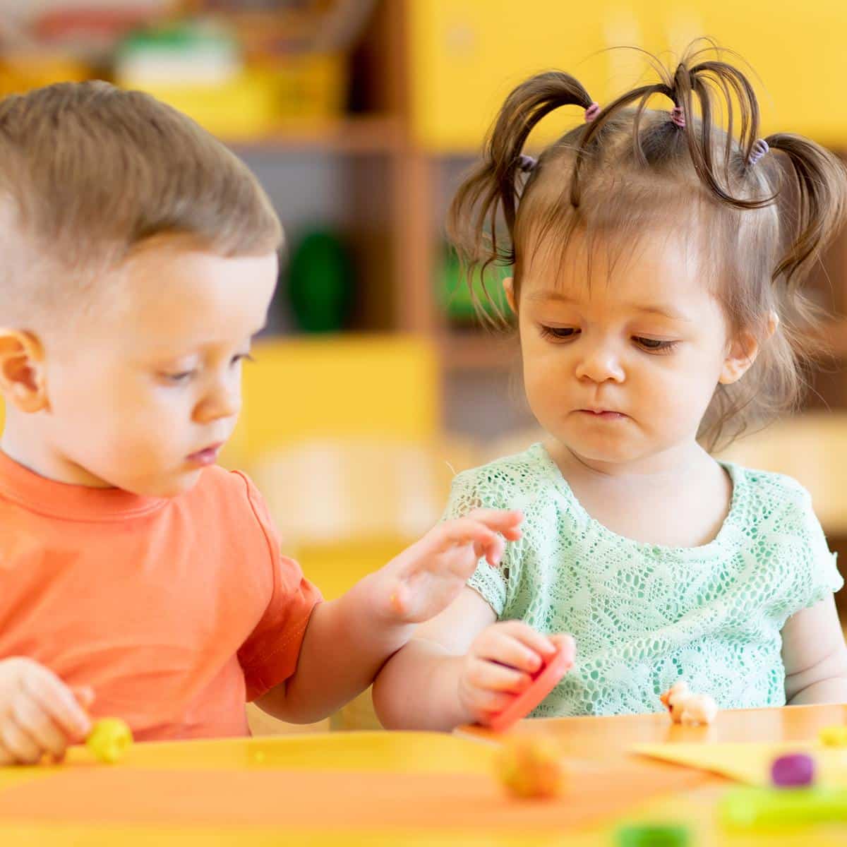 two young kids playing with shapes