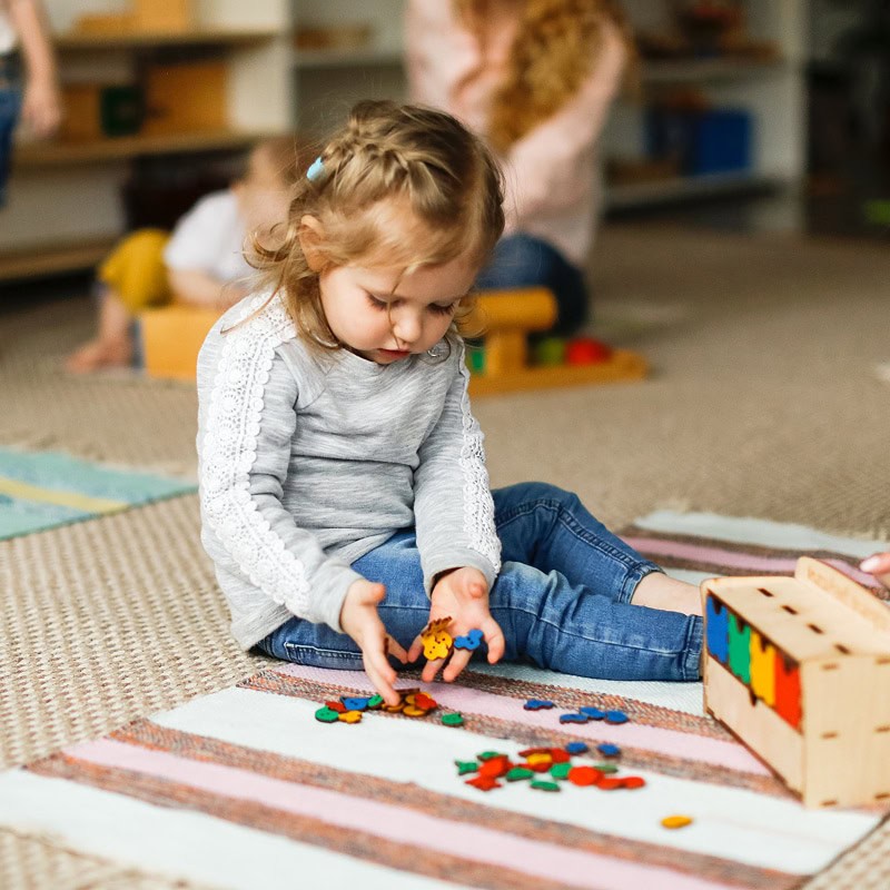 young girl playing with legos