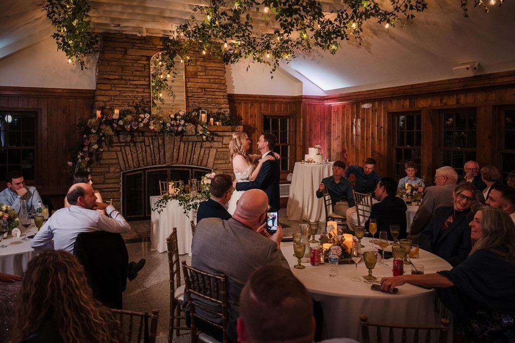 Bride and groom share their first dance during wedding reception at Lake Ellyn Boathouse in Glen Ellyn, IL