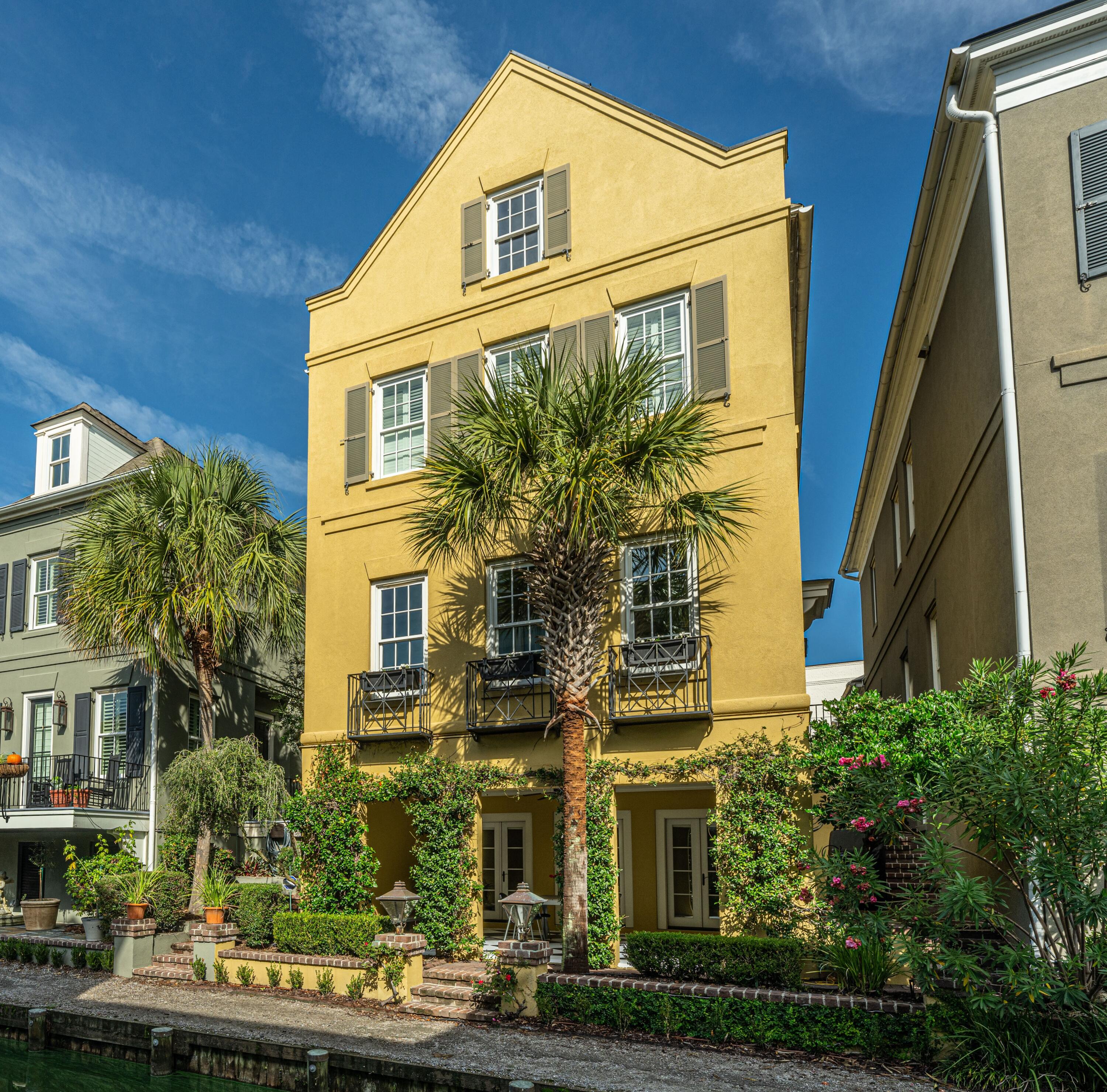 Stunning custom home in the desirable I'On neighborhood overlooking the canal with views of Eastlake. 55 Rialto Road is a 5 bedroom, 4.5 bath three story home with carriage house featuring an open and flexible floor plan, custom millwork, Brazilian cherry floors, and traditional Charleston architectural elements. Like being in historic downtown, the charming brick walkway passes the courtyard with fountain and leads to the home's Charleston style side entrance. Quality craftsmanship, high ceilings, and architectural details welcome you to the open light-filled living and dining room overlooking the canal. The gourmet custom kitchen with an induction cooktop and granite countertops and the great room with gas log fireplace overlook the courtyard for a private and cozy feel. A pantry,multiple closets for storage, and half bath complete the comfortable main living area layout. Upstairs the large and bright primary suite overlooks the canal and features a large walk in closet with custom organization system. The updated and spa-like primary suite bath has a large double sink vanity, freestanding soaking tub, and large frameless glass shower with floor to ceiling tile, double shower heads, and bench. Two additional bedrooms and an updated hall bath with double sinks and tiled tub/shower in separate space for added privacy. The laundry is also conveniently located on this level.

The lower level of the home offers a large family room or flex space that opens up with three sets of French doors to a covered loggia on the canal with beautiful landscaping and gas lanterns. Off of this space is the 4th bedroom with full bathroom and large closets for a private mother-in-law suite in the primary home. Through the quaint Charleston style brick courtyard complete with its own pineapple fountain is the carriage house with a two car garage and more finished living space. The carriage house boasts vaulted ceilings with lots of natural light, a full bathroom, and space to add a kitchen to make it a full apartment for guests or a potential rental (see HOA guidelines). This home has endless options to customize the spaces to accommodate many different stages in life.

The I'On neighborhood offers tree-lined sidewalks, green spaces, marsh front trails, and many walkable shops and restaurants in I'On Square and nearby. Community events are frequent and offer a variety of activities for all ages. Residents have access to the dock and boat ramp at the Creek Club and have rental privileges of the clubhouse for special events. Membership to the I'On Club is available for tennis, swim, and exercise facilities. This neighborhood offers it all, while being just minutes to historic downtown Charleston, the beaches, and zoned award-winning public schools. This home and sought-after neighborhood offer all you need for quintessential Charleston style living!