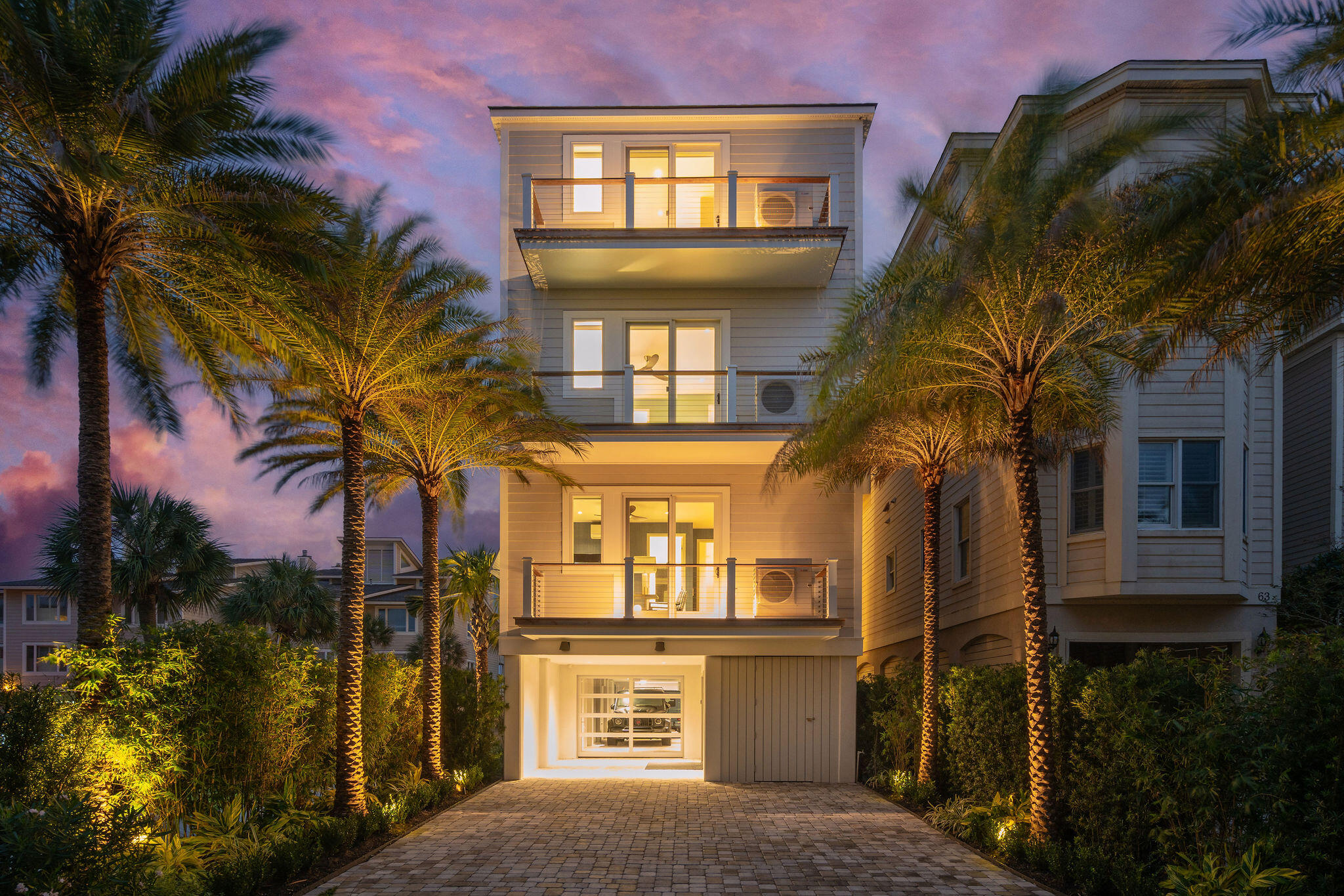 An exceptionally well-renovated home along the expansive front beach of Isle of Palms, this remarkable property features rarified air and quality finishes. This turnkey property will exceed the expectations of even the most discerning buyers. The spacious living space on the main level features a custom kitchen with walnut cabinetry and a quartzite waterfall island and backsplash. A hidden walk-in butler pantry is tucked away, perfect for easy serving during parties and storing appliances. The oversized wet bar features a beverage fridge and an extensive wine cooler tower for your collection, and this offers a great space to serve guests enjoying the wide oceanfront porch off the living room.A stunningly beautiful office with a full bath and closet and a charming powder room with custom lighting complete this main living level.

Upstairs, the beautiful oceanfront lounge provides a welcome respite to enjoy the views and could even be used as a bedroom with a full en suite bath. Two additional bedrooms with en suite baths, walk-in closets, and a nice-sized laundry closet for guests offer a pleasant respite on this level. The third floor has two large primary suites, each with large walk-in closets, and the rear primary suite offers magnificent oceanfront views and a private balcony. A spacious laundry room provides a ThinQ dry cleaning unit built-in and full-size units for the owner level. The high end elevator services all levels of the home, and this property could be configured to be a six-bedroom home if desired. 

Inside and out, 64 Grand Pavilion offers a quality finish unlike most in the area, with solid white oak flooring, custom glass, steel floating staircase, all custom lighting selections, and all bathrooms offering custom tile, natural stone, and heated flooring. Even the closets maintain the highest quality standards. Enter the home's outdoor space to find IPE decks, steel railings, Bahama shutters, extensive landscaping, and all moonlit and full-width slider doors, bringing the outside in on all levels. The parking is very comfortable, with a 4 car garage and 3 car driveway parking. 

Amenities abound in Wild Dunes, including two oceanfront pools, retail outlets, a spa/salon, and restaurants. This oceanfront home would garner significant rental income if desired. It is built for large-scale entertaining and has comfortable and private guest suites. Schedule your showing today to discover this one-of-a-kind property. Current appraisal in hand, furnishings negotiable with an attractive offer.