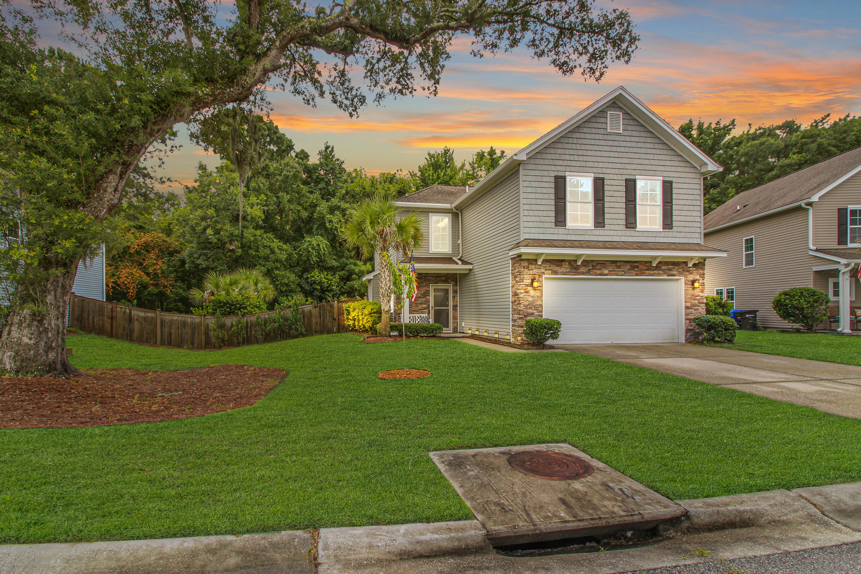 Gorgeous, upgraded home with a private backyard oasis! This 4-bedroom home shows better than a model! Located at the end of a quiet street backing up to woods, you will find NO drive thru traffic! The hallway entrance welcomes you into this open concept floorplan. Durable wood floors span the entire 1st floor. The kitchen is well-appointed with cream cabinets along with several decorative glass panel cabinets. Granite countertops, upgraded stainless steel appliances and a tiled backsplash give this kitchen a custom look. New pendent lights hang above the area for casual bar stool seating. The spacious family room has a gas fireplace. The Sunroom overlooks the picturesque view of the private, wooded backyard! Your backyard oasis includes a HUGE patio with pavers featuring a fenced in backyard and several palm trees for a more coastal feel. Upstairs you will find the master suite and 3 additional guest bedrooms. Enjoy the upgrades throughout this home including the iron railing, upgraded mirrors, lighting and ceiling fans! The spacious master suite has a trey ceiling, 3 decorative picture windows, and a walk-in closet. The master bathroom has a dual vanity, beautifully tiled shower, and soaking tub. The 4th guest bedroom is large enough (15' x 17') to be used as a 2nd family room, playroom or movie room. This home also has an attractive stone front and plantation shutters in most of the windows. Enjoy the energy efficient tankless water heater! This home is better than new, excellent condition, neutral paint, natural light and upgrades! Tupelo has a community pool, pavilion, firepit, and play park. Enjoy the top ranked, sought after Mt Pleasant schools!