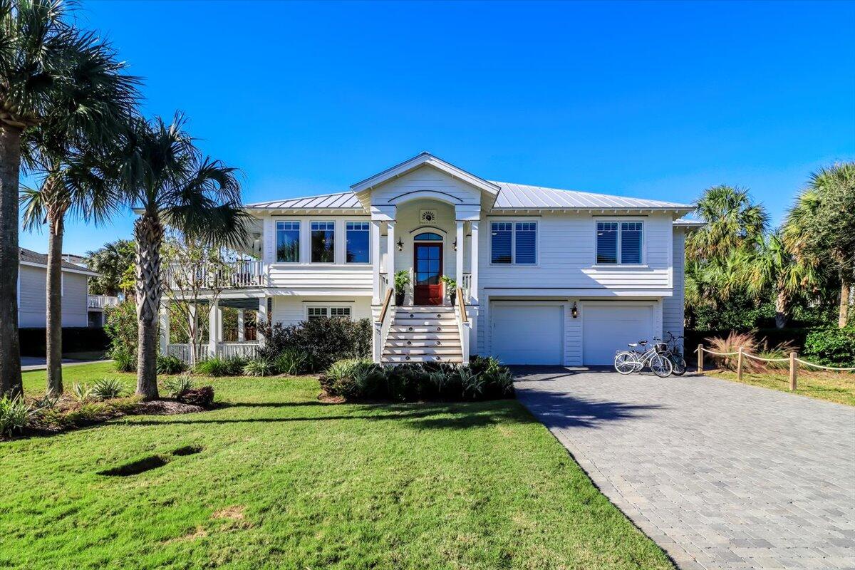 Nestled on a quiet street in the sought after upper avenues of Isle of Palms. Welcome to 3 43rd, a stunning 5 Bedroom 5 Bathroom coastal retreat steps from the beach offering the perfect balance of classic charm and modern luxury. This property has been thoughtfully updated through a major renovation completed in 2021 ensuring that every detail enhances function, style and the breathtaking views of the Atlantic ocean.As you step inside you will notice the interiors meticulous design, reflecting a relaxed coastal lifestyle, with exposed beams, shiplap walls, and custom flooring throughout. The open concept living area includes a bright and airy living room where you can relax and watch the waves, a chef's kitchen with a large island and bar area, and a dining space that comfortably seats 10. High-end appliances and thoughtful storage solutions make the kitchen both beautiful and practical, perfect for entertaining or everyday use.
Off the Kitchen you can head to the primary bedroom located in the newly added wing of the home. The suite is a private sanctuary featuring a cozy sitting area, Juliette balcony overlooking the pool and a huge spa-inspired bathroom with a combined walking shower and soaking tub, dual vanities, and a custom walk-in closet with a private washer and dryer. Just off the primary wing you will find a fully equipped workout room with a Peloton bike, treadmill and more. Additional bedrooms include a second king suite on the main level, two queen bedrooms, and a twin room, each with its own en-suite bathroom, providing ample space and privacy for family and guests.
The lower level features an additional bedroom, full bathroom and a bonus family room that provides a comfortable space for casual living, with direct access to the outdoor living areas for seamless indoor-outdoor enjoyment. The 2 stop elevator is also located in the lower level for convenience.
The exterior of the home showcases coastal craftsmanship, with Ipe entry steps and landing, a new metal roof, and expansive wrap around porches that provide the perfect spot to enjoy the ocean breeze and island views. The homes outdoor living spaces are equally impressive, featuring a saltwater pool with a tanning shelf, a seven seat saltwater hot tub, putting green, ground level Trex decking, and custom designed pavers that surrounds the pool area for a low-maintenance, high impact finish.
Whether you're seeking a primary residence, second home or a strong vacation rental investment, 3 43rd offers a rare opportunity to own a second row, coastal one of kind property that you do not want to miss. From the carefully curated outdoor spaces to the elegantly appointed interiors, every aspect has been designed to create a relaxing retreat that feels like home. This property is being sold mostly furnished.