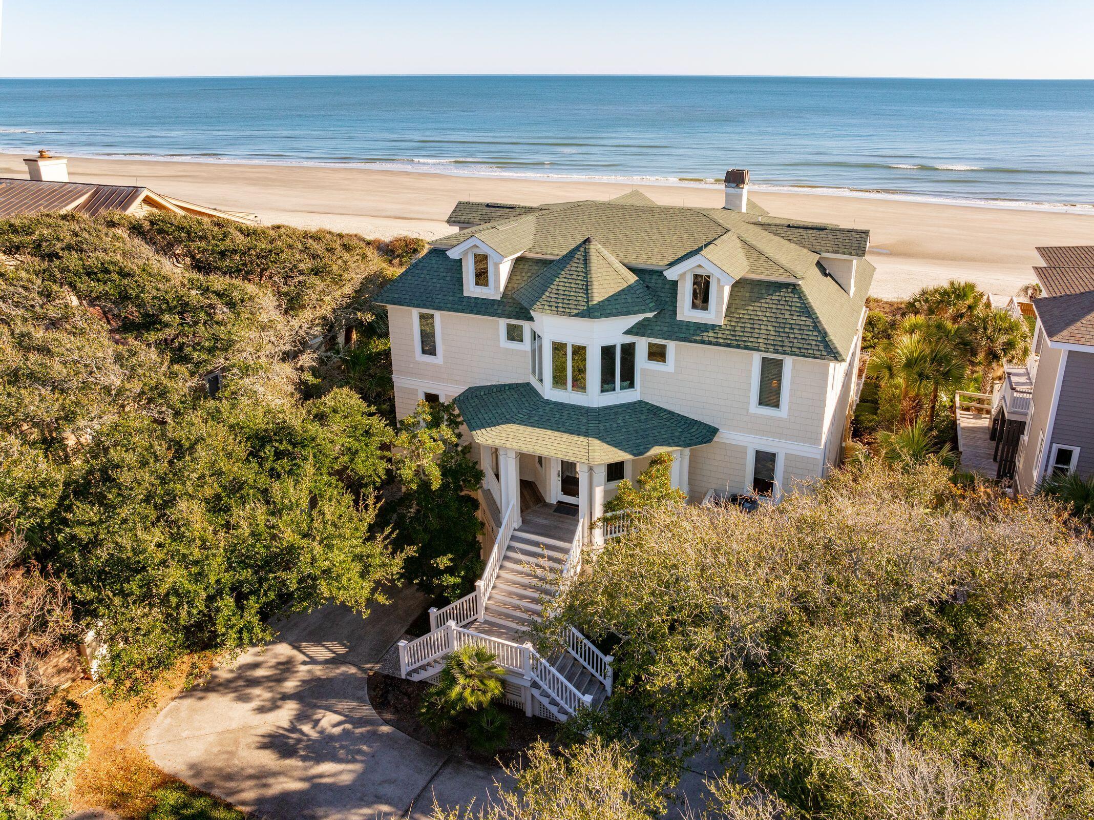 An oceanfront sanctuary offering unrivaled panoramic views of the Atlantic Ocean and seamless access to the sandy shoreline. Nestled on the most coveted side of Isle of Palms, this rare gem is truly a must-see.Step into the foyer, where breathtaking  views captivate you and flow through the living room, spacious kitchen, dining area and luxurious Primary bedroom suite. The screened porch is perfect for al fresco dining, with the soothing rhythm of waves & salty ocean breezes enhancing every moment. As the day winds down, relax on one of the many decks and soak in a stunning sunset. Whether you're seeking a peaceful retreat, a family vacation home, or a lucrative investment, 518 Ocean Blvd delivers it all. It's not just a house; its' a lifestyle and experience waiting to be created.