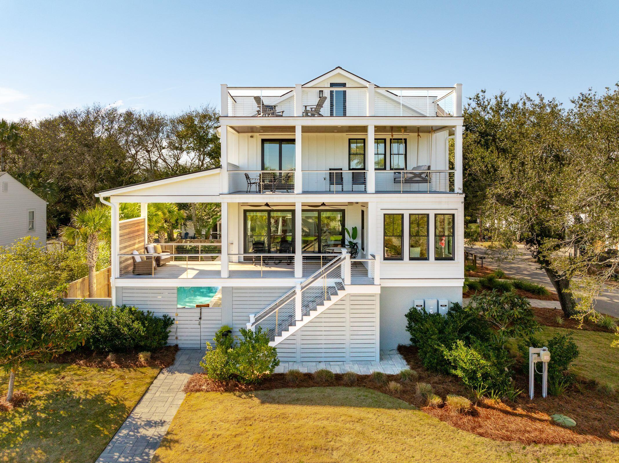 Welcome to 2606 Cameron Boulevard, situated in prime island location on a stately oak framed corner lot. This central Isle of Palms location cannot be beat...just steps away from the beach, the IOP recreation center & some of the best island restaurants! As you enter, you are warmly greeted by a light filled entry foyer adorned with charming coastal shiplap walls, setting the tone for the relaxed island lifestyle that awaits! A light & bright, spacious & open floor plan offers an ideal setting for gathering with family & friends. The living room features an expansive wall of glass doors lead to breezy porch that offers peeks of the Atlantic Ocean & is complimented by custom shelving & cabinetry that adds a chic aesthetic. The kitchen is a culinary dream equipped with top-of-the-lineBertazzini appliances, accented with elegant quartz countertops. Expansive bar seating allows for casual dining while the adjacent dining area provides the perfect gathering space with the ultimate functionality & sophistication. Dual dishwashers, as well as a wine & beverage refrigerator are an added convenience when hosting family & friends. A pantry with built-in shelving provides additional functionality & storage. On the main floor, there are two spacious ensuite bedrooms as well as a powder room. Retreat to the second floor to discover the owner's suite, the epitome of luxury featuring it's own private porch with views of the ocean & a bed swing for curling up with your favorite book. Spa-like bath features a designer tiled shower with seamless glass door, spacious vanity with dual sinks, private water closet & indulgent soaking tub, offering a total sanctuary for relaxation & rejuvenation. A walk-in closet with built-in shelving, drawers & desk enhance the functionality of this space. Two additional spacious ensuite bedrooms complete the second level, providing ample space for family or guests. This very thoughtful floor plan ensures privacy & convenience for all.

For endless fun in the sun, a saltwater pool & spa awaits. A spacious outdoor covered patio with outdoor kitchen expands poolside entertaining while the lower level rec room complete with view-through roll up doors, create a casual space for family fun. The Coastal Stone floor is easy to keep clean & features a non-slip surface, ideal for poolside entertainment. An outdoor shower to wash away the salt from your day at the beach is another outdoor luxury for simply the finest coastal living. The professionally landscaped yard, pool, porches & patios offer the ultimate setting for Lowcountry evenings. As the sun sets, the outdoor areas come to life, creating an enchanting ambiance that is perfect for entertaining or simply unwinding.

This home offers a turn-key opportunity as it has been meticulously furnished with classic, coastal style & most furnsihings will convey. Custom window treatments & wood shutters add a touch of refinement throughout the home, complementing & completing the sleek design. The wide plank white oak hardwood flooring throughout exude casual warmth & sophistication.

An elevator offers easy access from garage. Metal roof, garapa decking & cement plank board & batten siding provide stylish, yet durable & low maintenance island living.

Energy efficiency meets comfort, thanks to the addition of spray foam insulation in the attic. This upgrade not only contributes to a more consistent & comfortable indoor climate but also enhances the home's overall energy efficiency & the tankless hot water heaters offer additional energy efficiency while adding a touch of modern convenience to your daily routines.

Maintain optimal comfort year-round with the comfort of 3 HVAC units, delivering efficient climate control & peace of mind as well as a climate controlled lower level, including garage, offering moisture free storage for all of your coastal toys such as golf cart, bikes, surfboards, paddleboards, beach chairs & fishing gear.

An interior sprinkler system, a luxury not typically found in residential homes, is yet another feature of this home & will add cost savings for years to come.

The multi-zone irrigation system ensures that your landscaping stays lush & vibrant, requiring minimal effort on your part.

Plenty of off-street parking for convenience when hosting family & friends.

Walk to the vibrant Isle of Palms recreation center where you'll have easy access to an array of exciting amenities, including brand-new pickleball & basketball courts, tennis courts, baseball & soccer fields, children's playground, a dog park & much more, guaranteeing endless opportunities for active recreation while you are enjoying your coastal lifestyle. Take a short 7 minute drive to Shem Creek for more incredible waterfront dining options! Historic Downtown Charleston is just 20 minutes away for top notch culinary, shopping, arts & entertainment & the Charleston airport is just 25 minutes door to door.

This newly built chic island home is a R A R E find, offering a perfect blend of style, functionality & outdoor enjoyment where every detail has been meticulously curated to create a home that fully embraces the coastal lifestyle! Don't miss this opportunity to make this beach oasis your next primary, vacation &/or investment property!