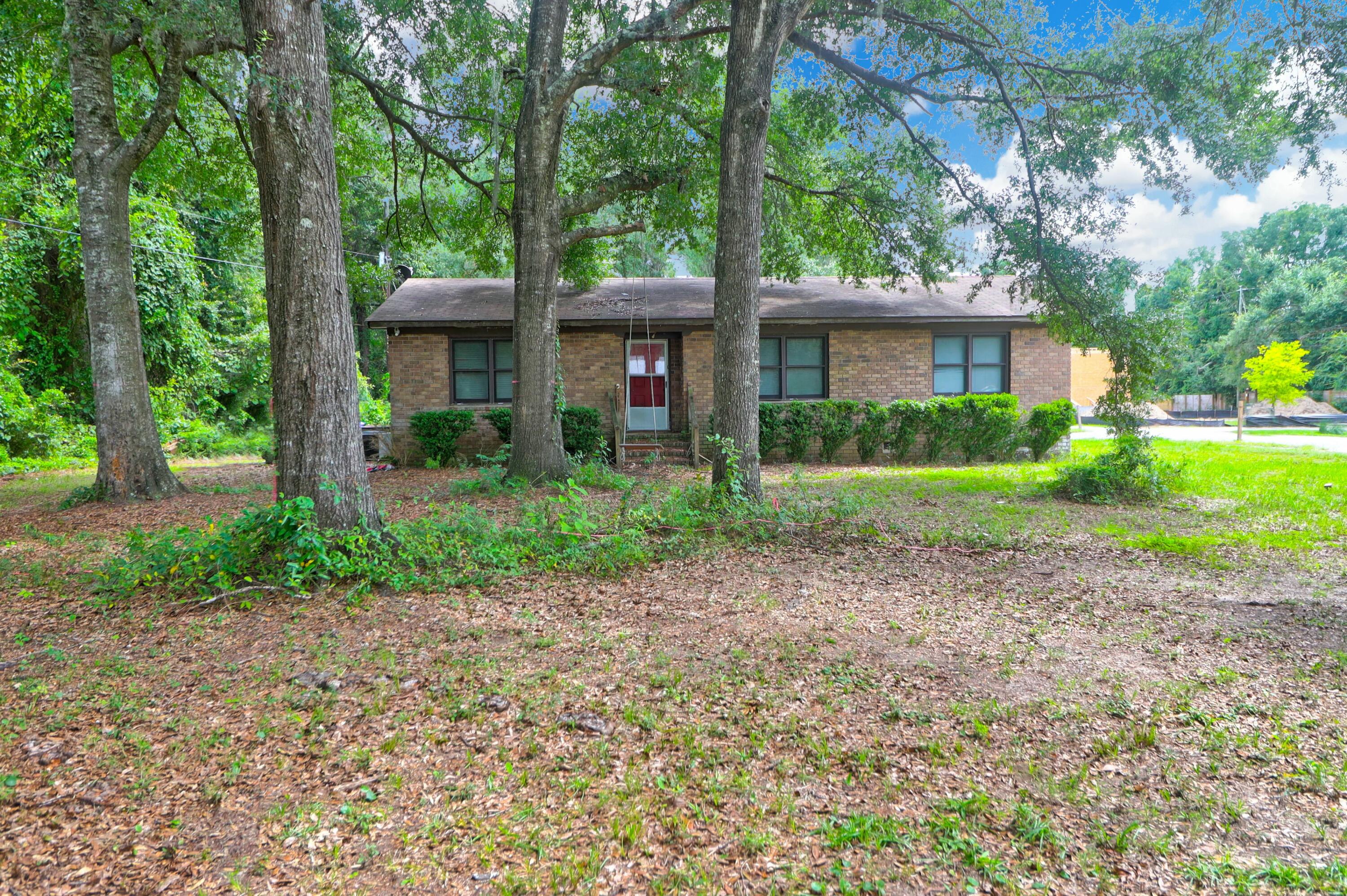 Tucked away down a quiet and wooded drive in South Mt. Pleasant, is 1088 Quiet Road.  Now is your opportunity to own .46 acres, only minutes from the Ravenel Bridge downtown, Sullivan's Island, and Whole Foods + Trader Joe's!  This charming and sturdy brick ranch home offers 3 bedrooms and 2 full baths, and is ready for you to put your touches on it!  No HOA, so bring your boat or RV!  Retreat away from the busy day to this serene setting, just minutes away from Shem Creek restaurants and shopping. (Please note this is larger parcel, .46 acre, for home plus vacant lot currently listed next door.)