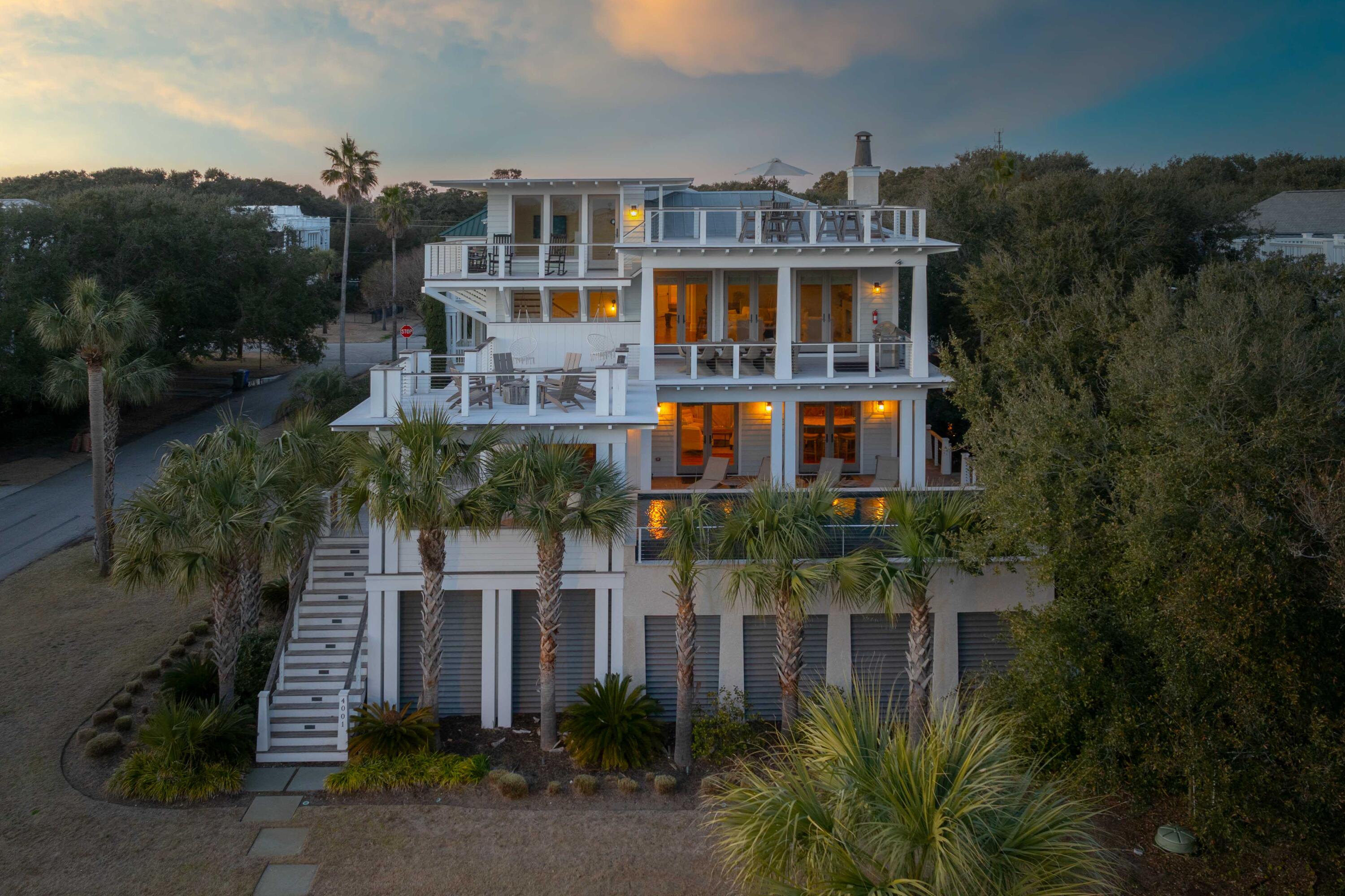 An Iconic Coastal Retreat Just Steps from the BeachWelcome to 4001 Palm Blvd, a stunning second row coastal masterpiece with sweeping ocean views that defines luxury living on the Isle of Palms. Situated just steps from the sand and crystal-clear waters of the Atlantic Ocean, this 5,000-square-foot home designed by renowned architect Carl McCants offers an unparalleled blend of luxurious design, comfort, and charm. Fully furnished, meticulously curated, and ready to offer you the ultimate move-in ready experience, this home is sold stocked with everything you could ever need. With 6 spacious bedrooms and 6.5 baths, this extraordinary home is perfectly suited for both intimate family living and grand-scale entertaining. The expansive, open-concept design creates a seamless flowbetween indoor and outdoor spaces, inviting natural light and ocean breezes into every corner. Whether you're hosting guests, enjoying a quiet sunset, or cooling off in the infinity-edge saltwater pool, 4001 Palm Blvd elevates the art of beach living to a whole new level.

Sophisticated Main Living & Chef's Kitchen
The heart of the home is the show-stopping chef's kitchen, fully equipped with the finest Viking appliances, including an 8-burner dual-fuel range with side-by-side ovens, a Blanco sink, and an expansive center island with a prep sink. Custom cabinetry, sleek quartz countertops, and a oversized pantry offer both form and function, while the built-in dual-zone wine fridge and beverage station make entertaining a breeze. The open dining and living areas flow effortlessly onto the Ipe decks, creating an expansive outdoor living space with sweeping views and refreshing sea breezes.

Main Suite: Your Own Private Sanctuary
The only bed on the second floor, the main suite is a true sanctuary, offering a private sitting area that could easily serve as a home office or reading nook. The walk-in closet is a dream, with ample space for your wardrobe and accessories. The spa-inspired en-suite bath features a stand-alone soaking tub, a luxurious rainfall shower with dual shower heads, and beautiful shiplap accents that bring a touch of coastal charm to this tranquil retreat.

Guest Suites & First-Floor Entertainment
The first floor boasts five additional bedroom suites, each with its own private bath and oversized shower with dual shower heads, offering both privacy and comfort for family and guests. A standout feature of this level is the media/game room, complete with a full bar, two beer taps, and a Golden Tee golf machine for hours of entertainment. With its direct access to the backyard and pool deck, this space makes entertaining effortless.

Outdoor Oasis & Incredible Views
The outdoor spaces are nothing short of spectacular, with expansive Ipe decks wrapping around the home to provide the perfect setting for outdoor dining and relaxation. The sparkling saltwater infinity pool overlooks the lush backyard, complete with synthetic turf for a pristine, low-maintenance lawn. The outdoor shower adds a touch of convenience after a day at the beach. Whether you're lounging by the pool or enjoying a cocktail on the deck, the gentle sea breeze and serene surroundings will make every moment feel like a vacation.

Exceptional Features & High-End Finishes
- Brazilian cherry hardwood floors throughout have been lightly refinished in the last week
- Sonos sound system with surround sound in every room
- Smart home wiring for advanced automation and control
- Two Rinnai water heaters for endless hot water
- Central vacuum system for easy cleaning
- Metal roof for durability and style
- Shiplap wall accents that create a beachy, elegant vibe
- Two outdoor showers
- Four to six-car garage 

Minutes from world-class golfing, boating, and gourmet dining, and only 15 minutes from the historic charm of downtown Charleston, this home offers the ultimate balance of seclusion and convenience. Whether you're looking for a luxurious vacation retreat or a full-time island residence, 4001 Palm Blvd promises the best in Lowcountry living.