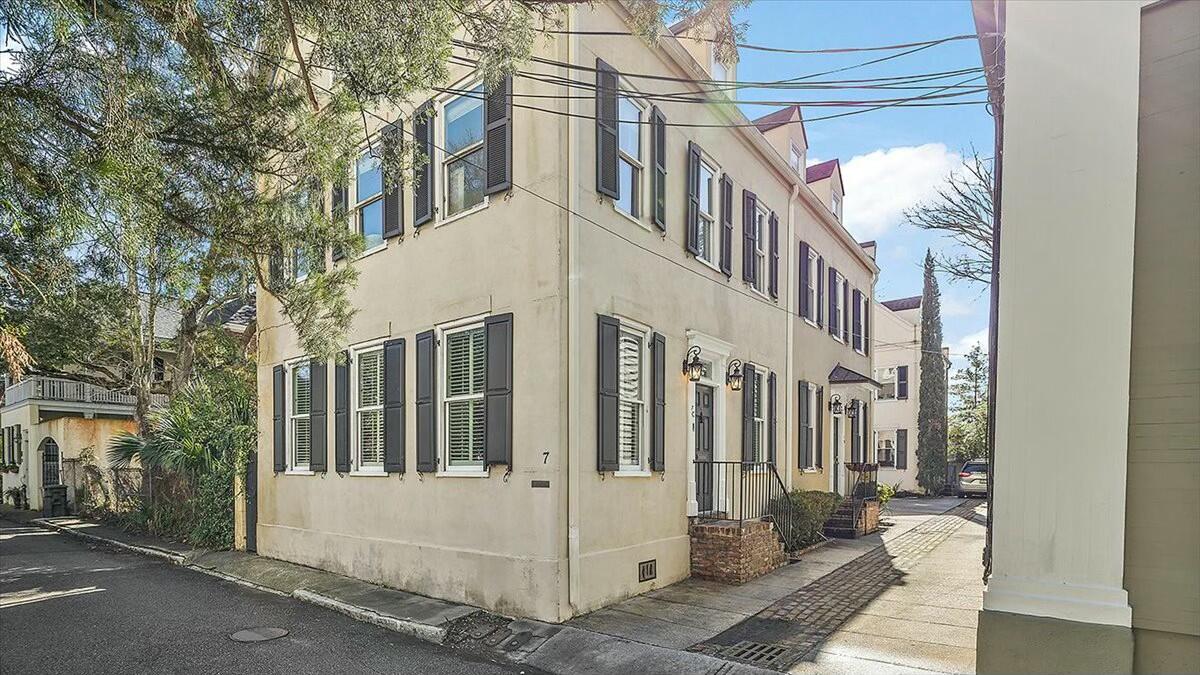 Elegant townhouse perched on elevated ground in historic Harleston Village. Just steps from King Street's renowned antique district, offering world-class shopping and dining at your doorstep.  The fully renovated gourmet eat-in kitchen is breathtaking, featuring custom cabinetry, granite countertops, and high-end Viking appliances. It seamlessly flows into the living room, where a cozy gas-burning fireplace adds warmth and charm.  Follow the elegant, curved staircase to the second floor, where you'll find two spacious bedrooms connected by a Jack-and-Jill bathroom, each with its own private half-bath and a shared shower. A conveniently located laundry room serves the second-floor bedrooms.The entire third floor is dedicated to the luxurious primary suite, featuring a spacious bathroom, a walk-in closet, ample storage, and breathtaking rooftop views.

This home boasts exquisite interior finishes, including intricate crown moldings and antique wide-plank heart pine floors throughout all three levels. 

With two deeded off-street parking spaces you can leave your car behind and explore the city on footno regime fees! Situated at one of the highest points in Downtown Charleston, historical maps confirm this area has always been high ground, requiring only minimal flood insurance with an X flood zone rating.