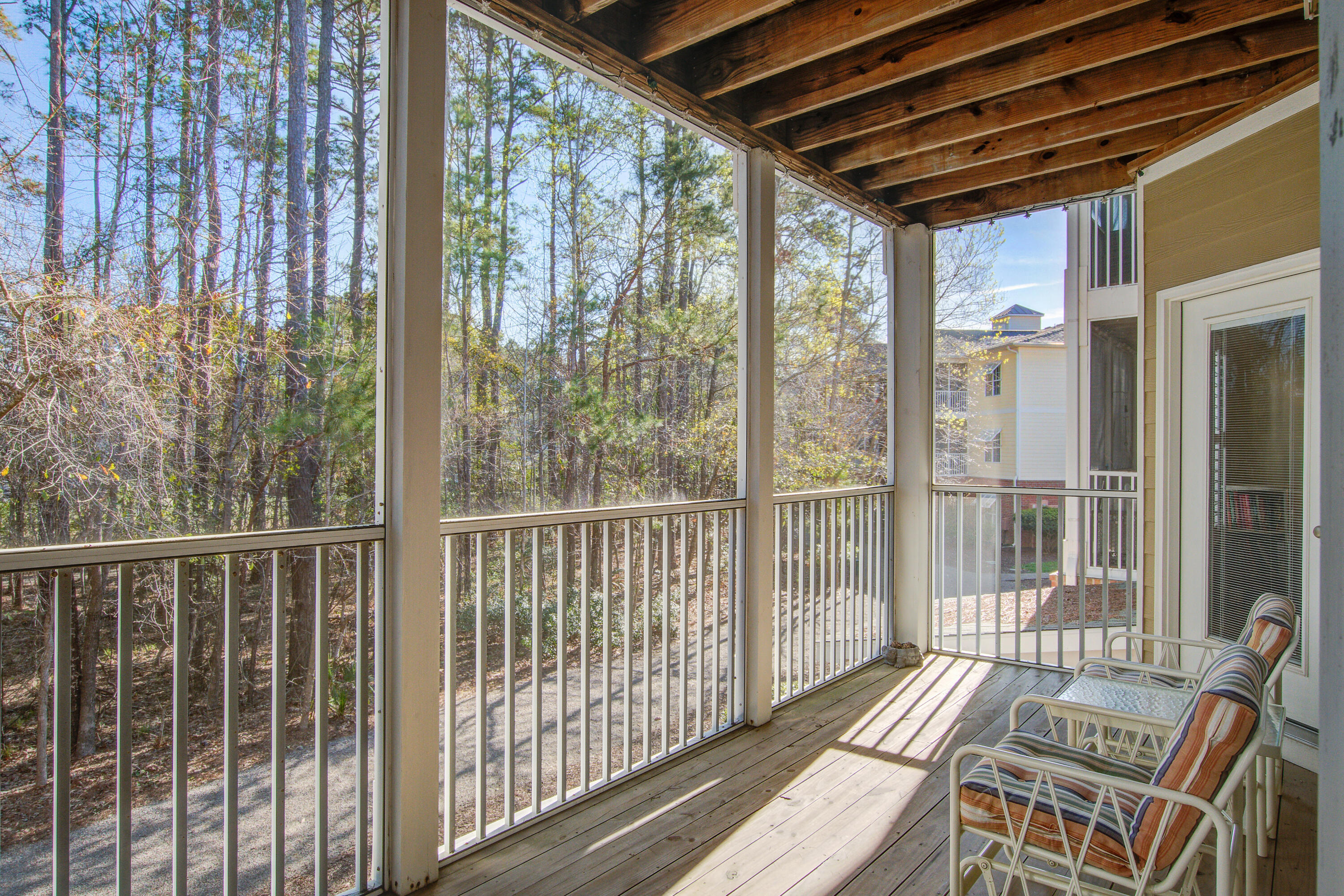 This beautiful bright condo has the perfect and private location on the second floor with wooded views! Having two large bedrooms this unit has a spacious 1,063 Sf.  The master bedroom has a large bathroom and walk-in closet! The kitchen is a great little hub open to the spacious living and dining combo room. The smooth ceilings, crown molding and beautiful hardwood flooring make this a must see.  The large screen porch overlooks the wooded area giving it the perfect situation for relaxing or entertaining guests to enjoy the outdoors and neighboring wildlife. Only 12 Miles from the beach makes this the perfect location in town. The Battery at Park West is a small condo community in the heartof Park West with ELEVATORS, its own Pool and Clubhouse to watch movies, join game night or use the work out center with great equipment. And don't forget the cook out and fire pit area, the ''Great Lawn', or dog park area! The condos are arranged in a circle so you will see walkers and bikers, enjoying the wooded serene area. Close to shopping, restaurants, and all other amenities one might need!