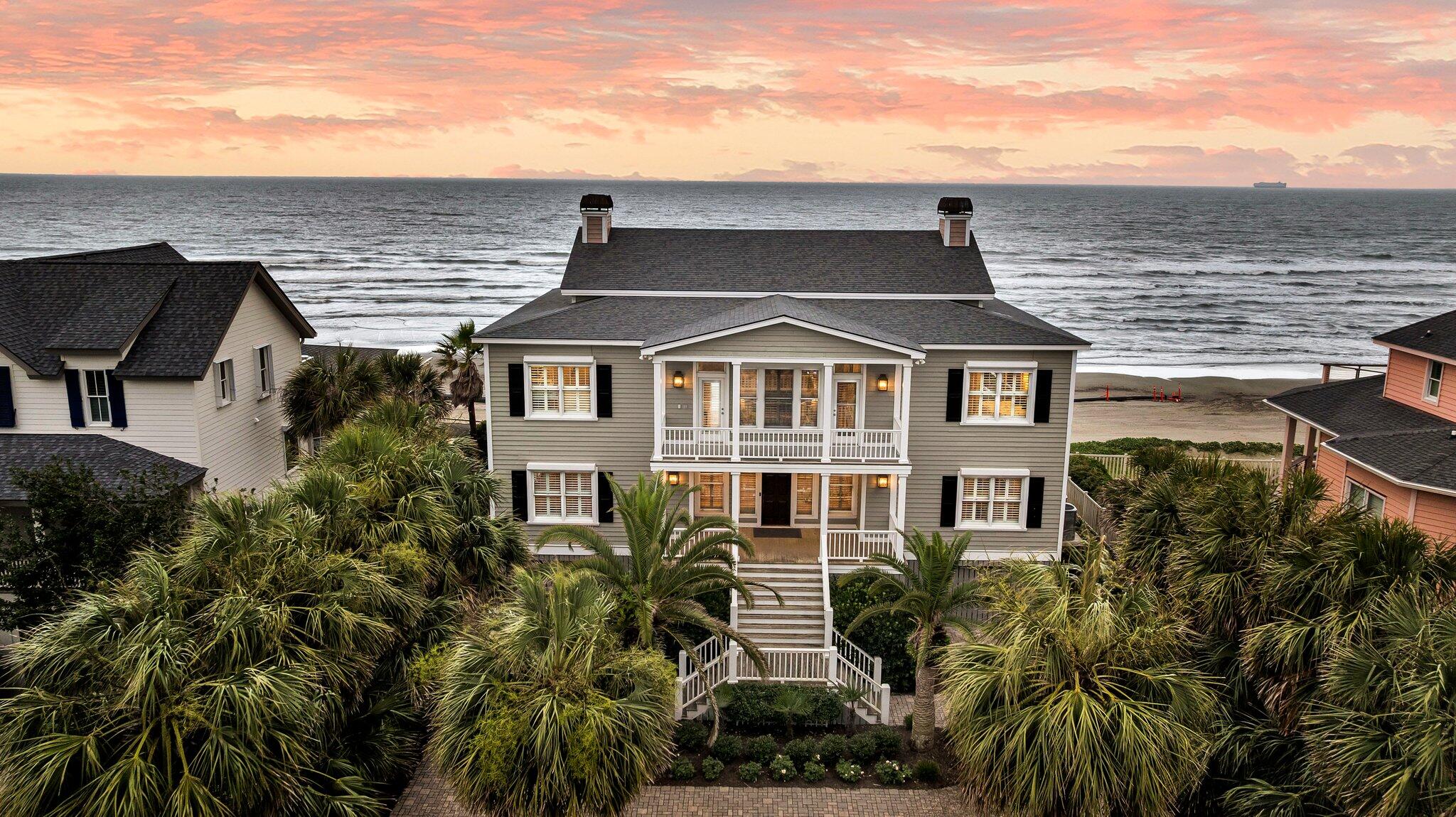 Welcome to your very own slice of paradise along the prestigious Millionaires Row, one of the most exclusive stretches of beachfront on the coast. With no public beach access or street parking nearby, you'll enjoy a quiet, private expanse of sand that feels like your own secluded oasis. This meticulously maintained 6-bedroom, 5-bathroom beachfront retreat offers 3,878 square feet of luxurious living and has never been rented in over 35 years, and it shows! Enter through your private, gated drive to a lushly landscaped sanctuary, framed by swaying palm trees, blooming perennials, and tall hedges that ensure privacy from neighbors.With parking for 12+ vehicles and no HOA restrictions, this home is ideal for hosting gatherings, enjoying multigenerational living, or converting to a high-end vacation rental. 

This home features a smart and stylish inverted floor plan, so all your main living spaces are perched upstairs, capturing the most incredible panoramic views. Downstairs, the bedrooms stay cool, quiet, and cozyperfect for relaxing after a long day at the beach. Every room in the house offers breathtaking ocean views and direct porch access, with wide porches spanning the entire width of the home for a seamless blend of indoor-outdoor living. Hardwood flooring flows throughout, adding warmth and cohesion to the elegant design. 

Upstairs, the open-concept living space is light-filled and expansive, anchored by a newly renovated gourmet kitchen featuring ceiling-height shaker cabinets, quartz countertops that extend up the backsplash, and top-tier finishes. The dining area opens effortlessly into the living room and out onto expansive oceanfront porchesperfect for al fresco meals with the sound of the waves as your backdrop. 

The primary suite is a true coastal sanctuary, complete with massive windows framing the Atlantic, a spa-like ensuite with a soaking tub, walk-in shower with stone surround, dual vanities with quartz counters, and a separate vanity for makeup or hair. Pour a glass of wine, step onto your private deck, and let the sound of the waves do the rest. Downstairs includes the oceanview primary bedroom and three additional guest bedrooms, all with porch access and stunning views. A three-stop elevator provides easy access to every level, and three newly remodeled bathrooms offer both luxury and convenience. 

Built to endure the elements, this home is a secured beachfront fortress, equipped with automatic hurricane shutters providing peace of mind, storm protection, and long-term investment security. Additional upgrades include a new roof (2021), two new HVAC systems (2020), spray foam insulation in the attic and sealed crawl space, and a dehumidifier system to keep the home dry, efficient, and comfortable year-round. 

The turfed backyard offers easy maintenance and ample room to add a pool, making it an ideal space for both relaxation and entertainment. Underneath the home you'll find abundant covered parking and storage, perfect for beach gear, bikes, and more. And on a clear day, the view stretches all the way to Morris Island Lighthouse and Folly Beach, making this one of the most spectacular vantage points along the coast.