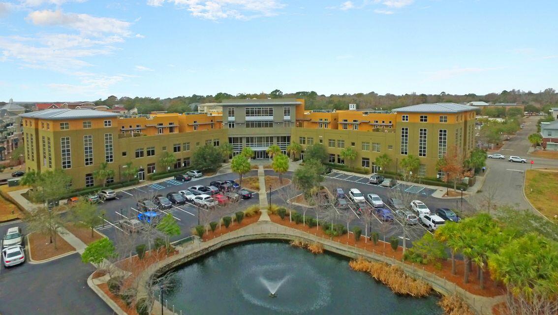 ***Ask about the possibility of receiving 1% reduction in interest rate and free refi.***Prepare to be amazed by this extraordinary penthouse located in the vibrant heart of downtown Daniel Island. Just steps from shopping, dining, the tennis center, and over 25 miles of picturesque walking trails, this home offers the ultimate in Lowcountry living.Inside, the open layout showcases beautiful flooring, detailed crown molding, and streams of natural light filtering through windows dressed with plantation shutters. The welcoming living room includes a fireplace framed by built-in shelves and cabinetry and flows effortlessly into the dining space.Opposite the stairwell, the gourmet kitchen features granite countertops, stainless steel appliances, a tile backsplash, a breakfast bar, and direct access to the porch. Upstairs, the generous primary suite offers a peaceful retreat with a luxurious ensuite bathroom that includes a dual vanity, an oversized soaking tub, and a spacious step-in shower. Two additional bedrooms, a full bathroom, and a laundry area complete the upper level.

This rare top-floor residence sits above office space and includes one assigned parking spaces. With Credit One Stadium just a short walk or bike ride away (under a half mile), this penthouse truly blends luxury, location, and lifestyle.

Don't miss the opportunity to make this exceptional Daniel Island home your own.