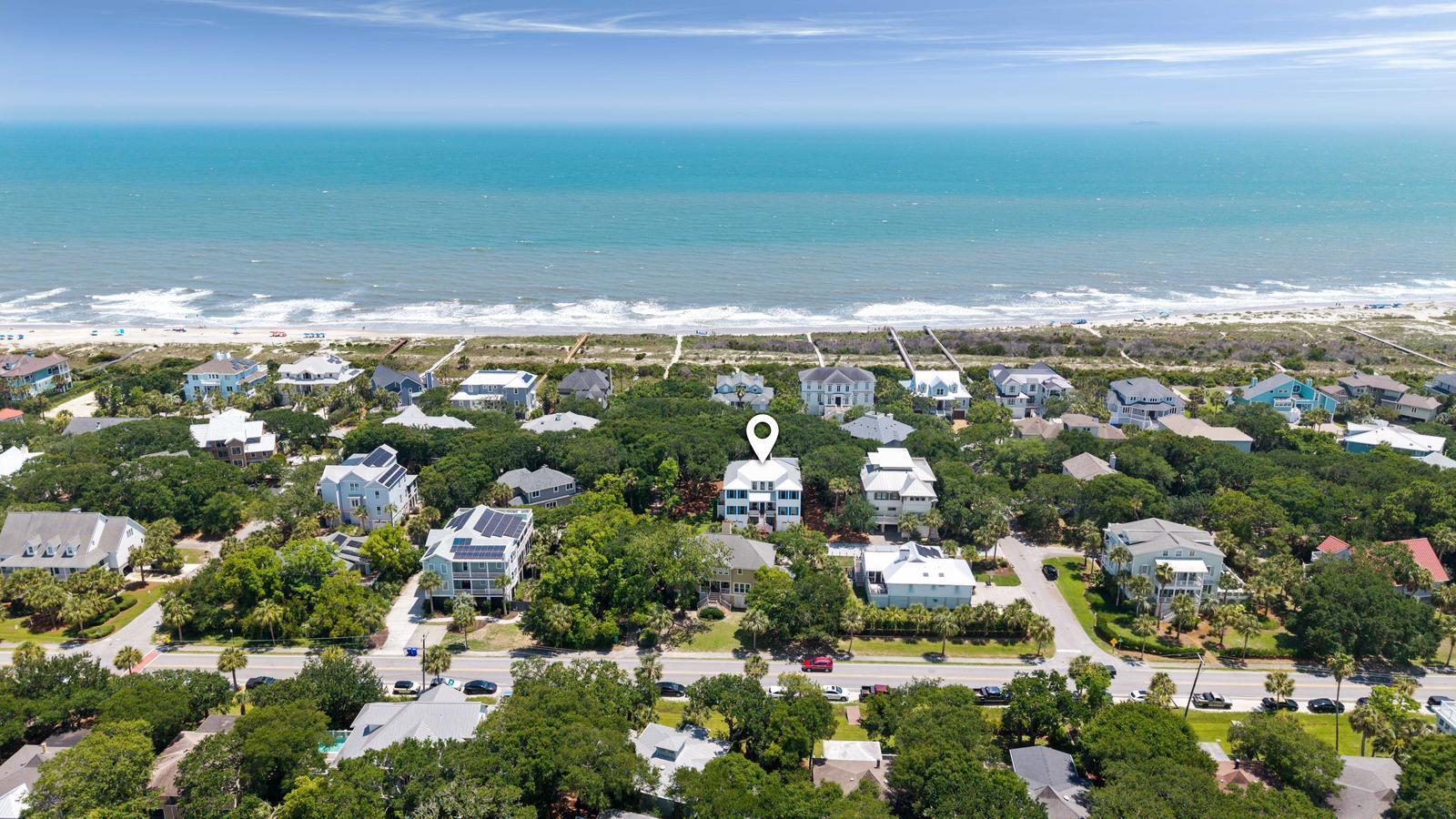 Welcome to 14 55th Avenue--2nd row newly built custom home just steps away from the beach. Located in the highly sought after section of IOP where the streets are quieter and walks are shorter to the beach. This 5 bed, 5.5 bath home sits in one of Isle of Palms' most desirable pockets--close to the marina, local dining, and Wild Dunes Resort - and has a direct path to the beach from the backyard - you'll never cross a street to get to the beach!.  Whether you're seeking a primary residence, a second home, or a rental property, this home has it all! Step inside to discover bright, open living spaces designed for everyday ease and relaxed coastal living. The chef's kitchen features custom cabinetry, a large center island, high-end finishes, and a walk-in pantry with a wine chiller. Two......guest suites on the main level offer privacy and comfort and the flexibility for a downstairs primary or office. Upstairs, the primary suite includes a spa-like bath, walk-in closet, and private porch access. A spiral staircase leads to a rooftop sundeckperfect for enjoying the breeze and listening to the ocean. Two additional bedrooms each with private baths complete the upper level. This home was also constructed with an elevator shaft to the top floor.
Outdoor living is just as inviting with a large screened porch overlooking the private saltwater pool, fenced-in backyard, lush tropical landscaping, and an outdoor shower for rinsing off after the beach. Elevated construction with a 3-car garage and additional parking spaces in the driveway to fit 3 additional cars.
Thoughtfully designed and perfectly located, 14 55th Avenue delivers the lifestyle so many come to Isle of Palms to findrelaxed, refined, and ready to enjoy!