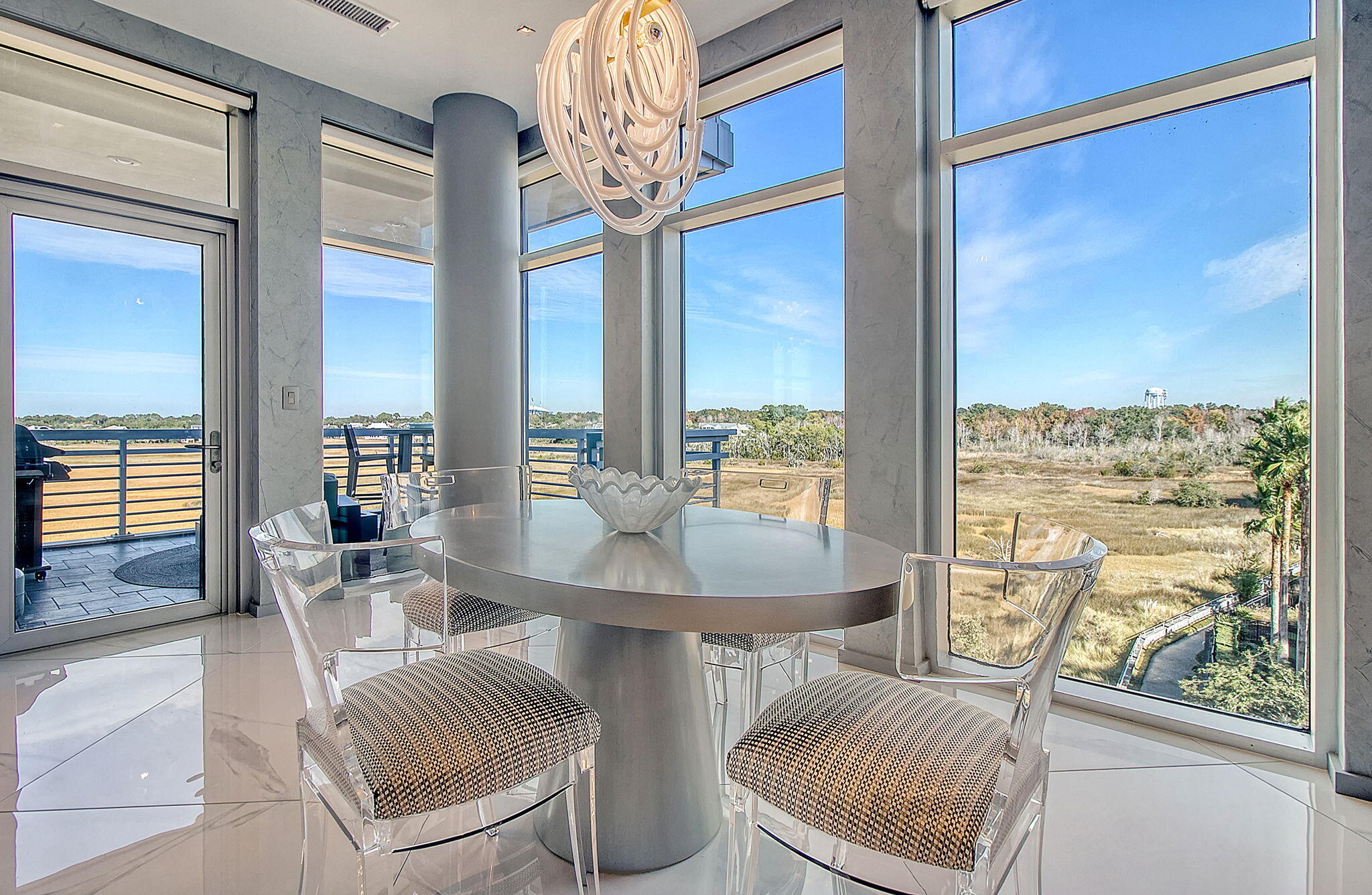 Live in a Work of Art.Perfecting the art of living becomes effortless when you reside in a work of art. This custom-designed corner-unit condominium--crafted through an extensive renovation--redefines sophistication. With three bedrooms and three full bathrooms, the residence masterfully fuses architectural brilliance with hand-curated design to deliver a lifestyle of unmatched elegance.Arrive by private elevator into a home where no detail has been overlooked. Striking 4' x 4' high-gloss porcelain tile flooring imported from Italy anchors the space, while 8' custom solid wood doors, inlaid with stainless steel panels and outfitted with mortise locks, set the tone for the exceptional finishes found throughout.At the heart of the home, the chef's kitchen is a true showpieceequipped with a Sub-Zero refrigerator, Sub-Zero wine fridge, Sub-Zero beverage drawers, Wolf range, Cove dishwasher, and Wolf drawer-style microwave. The Dolomite natural stone waterfall island, imported from Brazil, is wrapped in textured metal tile that continues onto a dramatic abstract accent wall, where a sleek gas fireplace is framed in Italian porcelain.

Ideal for entertaining, the spacious dining area adjoins a custom-built wine bar and opens to an oversized corner balcony where natural light and river breezes are part of the daily experience. Thoughtfully selected lightingincluding hand-blown glass chandeliers from Italy in the dining room, foyer, and hall bath, along with artisan pendant fixturesadds to the home's bespoke character.

Each bedroom is flooded with morning light and uniquely appointed. The guest bedroom features a striking natural wood wall covering crafted from sabago and mulberry. The primary suite offers a true sanctuary: a spa-inspired bath complete with a 73" porcelain and stainless steel soaking tub, expansive glass shower, and custom-built dual vanity with LED backlit mirrors. All bathrooms are finished with elegant marble flooring.

The flexible third bedroom doubles as a den or workspace and showcases a distinctive geometric wall covering made of natural wood, creating a serene and inspiring environment. Automated blinds and custom draperies accent each room, adding both comfort and sophistication.

Every tile, fixture, and finish has been meticulously chosen to impress the most discerning eye.

This home occupies one of the most coveted locations, offering serene morning sunrises and breathtaking sunsets-without the discomfort of the direct afternoon sun.

This is more than a homeit's a living masterpiece. A flawless fusion of luxury, design, and comfort, waiting for its next visionary owner.