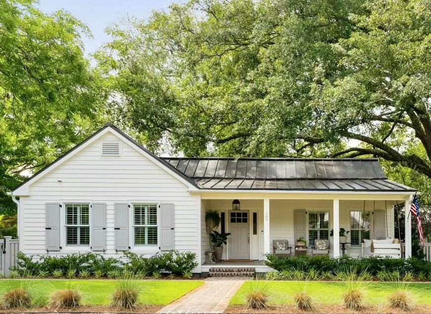 Welcome to 509 Klein Street -- a picturesque and inviting cottage, complete with a fully appointed one bedroom guest house, nestled beneath majestic live oaks in the heart of the coveted Old Village neighborhood. With 2,822 total square feet between the three bedroom, two and a half bath main home (2,306 sqft) and one bedroom, one bathroom guest cottage (516 sqft), there's ample space to relax, gather, and enjoy the very best of Lowcountry living. Thoughtfully renovated in 2023, this delightful single-story home effortlessly blends timeless charm with modern comfort. A new designer kitchen, a spacious primary suite, and a professionally landscaped oasis with a saltwater pool and alfresco dining areas make this property ideal for everyday living and effortless entertaining.A deep, welcoming front porch sets the tone  perfect for a summer swing or catching up with neighbors. Step inside to discover an open, sunlit interior with rich hardwood floors, a generous living room anchored by a cozy gas fireplace, and a refined dining area designed for gatherings both casual and formal. The reimagined kitchen is a showstopper, featuring custom cabinetry, Thermador appliances, unlacquered brass fixtures, and stunning Taj Mahal marble countertops. Whether you're hosting or gathering with family, each space in this home is designed to encourage connection. The main home offers three bedrooms, two full bathrooms, and a powder room. The serene primary suite features a large en suite bath with walk-in shower and multiple walk-in closets. Two additional bedrooms share a beautifully appointed hall bath, while a stylish laundry room with black-and-white checked tile adds a perfect touch of flair to functionality. Tucked away in the rear of the property, the guest cottage offers over 516 square feet of versatile space, including a living area, kitchenette, cozy sleeping enclave, and a renovated full bath perfect for visiting guests, a home office, or a private studio or gym. Through the French doors off the kitchen, a covered rear porch invites quiet mornings and relaxing evenings. The lush, private backyard is a true sanctuary complete with saltwater pool, hot tub, raised garden beds, and a central fire pit area designed for joyful gatherings and lifetime memory-making.  Beneath the canopy of a truly grand oak, enjoy unforgettable evenings under the café lights in the al fresco dining space, the perfect setting for outdoor entertaining. Set on a generous 0.24-acre lot, this move-in ready gem captures the essence of the Old Village lifestyle. Walk to Mount Pleasant Academy or Moultrie Middle School, bike or ride your golf cart to nearby Alhambra park, neighborhood tennis and pickleball courts, acclaimed local restaurants, and the iconic Pitt Street Bridge. Just minutes from downtown Charleston and the beaches of Sullivan's Island, this home offers the perfect blend of Lowcountry charm, comfort, and convenience.
