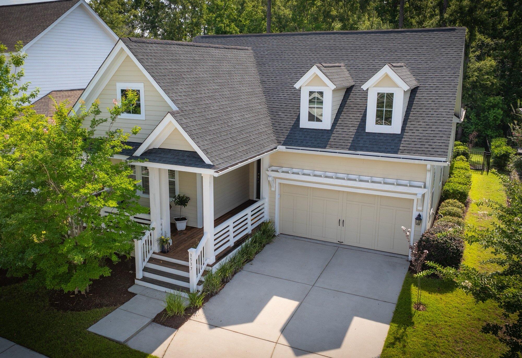 Welcome to one of the few true ranch-style homes available in the highly sought-after Carolina Park community--where coastal charm meets everyday convenience. Perfectly positioned near top-rated schools, the Wando Library, Costco, dining, and shopping, this one-story gem offers relaxed, easy living with everything you need just a golf cart or bike ride away.Built in 2019 and beautifully maintained, this Southern-style cottage invites you in with a wide front porch and a bright, open floor plan. The heart of the home is the stunning white kitchen featuring an oversized island, white subway tile backsplash, and imported granite countertops--ideal for entertaining and everyday gatherings. The spacious great room with gas fireplace flows seamlessly into the kitchen, while rich espressohardwood floors add warmth throughout the main living areas and bedrooms.

The primary suite is a private retreat with custom plantation shutters, dual vanities, a large walk-in closet, and serene woodland views. Two additional bedrooms, a generous laundry room, and a built-in drop zone add thoughtful functionality. Step outside to the screened porch and patio- perfect for unwinding while overlooking the protected wooded preserve behind the home.
Updates include:
New fence
All new appliances in the kitchen 
Custom closets in the primary bedroom closet
Added gutters to the exterior

Carolina Park offers an unmatched lifestyle with over 380 acres of parks, trails, marsh, and open green space. Enjoy the award-winning resort-style pool, tennis courts, playground, dog park, Great Lawn, and more. Whether you're downsizing, simplifying, or just starting out, this rare one-level home is a must-see in one of Mount Pleasant's most vibrant communities.