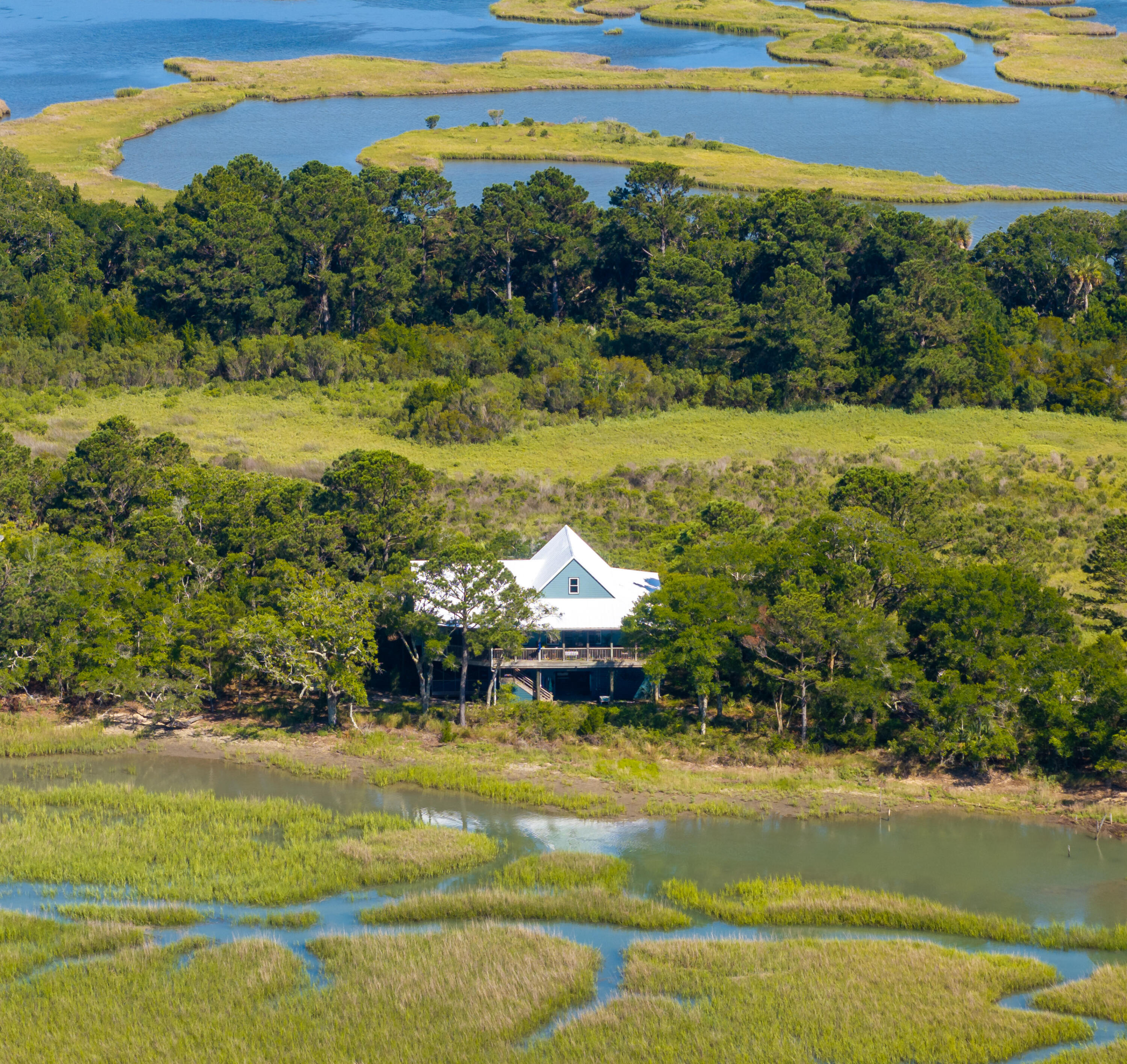 Step into your luxury beach retreat at 226 Old House Lane--where laid-back island elegance meets high-end comfort. This beautiful 5-bedroom, 3-bath home is nearly all on one level and thoughtfully designed to capture the magic of Dewees Island living.Enter into a spacious living room that flows seamlessly into the dining area, all under a dramatic vaulted ceiling. Sliding doors on both ends of the home invite the ocean breeze, creating an airy, indoor-outdoor vibe. The kitchen is a showstopper--featuring a large island, gas range, and a cozy sitting area perfect for sipping morning coffee while watching nature unfold.To the right, a junior primary suite offers privacy for guests.On the opposite wing, you'll find four additional bedrooms, including the primary suite with its own private porch. In the evening, unwind on your back deck with unobstructed marsh views and picture-perfect sunsets.

The oversized garage holds four golf carts, a boat, and all your adventure gear. Plus, there's another breezy porch for gathering with family and friends.

Recent upgrades include a full exterior refresh with Emerald Rain Refresha premium self-cleaning paint formulated to resist dirt and grime while offering superior UV and weather protection. The roof was meticulously restored: every rivet sealed, fully sanded, then finished with two coats of primer and a rubberized seal coating for long-term durability. Artificial turf adds low-maintenance charm to the back porch, and the home is equipped with a 250lb propane tank fueling the gas range and tankless hot water heater. A new fridge and freezer in the garage rounds out this turnkey coastal havenjust a short ride or walk to the ferry.

Dewees Island is Charleston's best-kept secretan exclusive, nature-focused community where serenity reigns and cars are left behind. With no commercial development and a deep commitment to conservation, it offers a truly unique coastal lifestyle. Plus, with short-term rentals now allowed up to 56 nights per year, this home doubles as a private retreat and an investment opportunity.