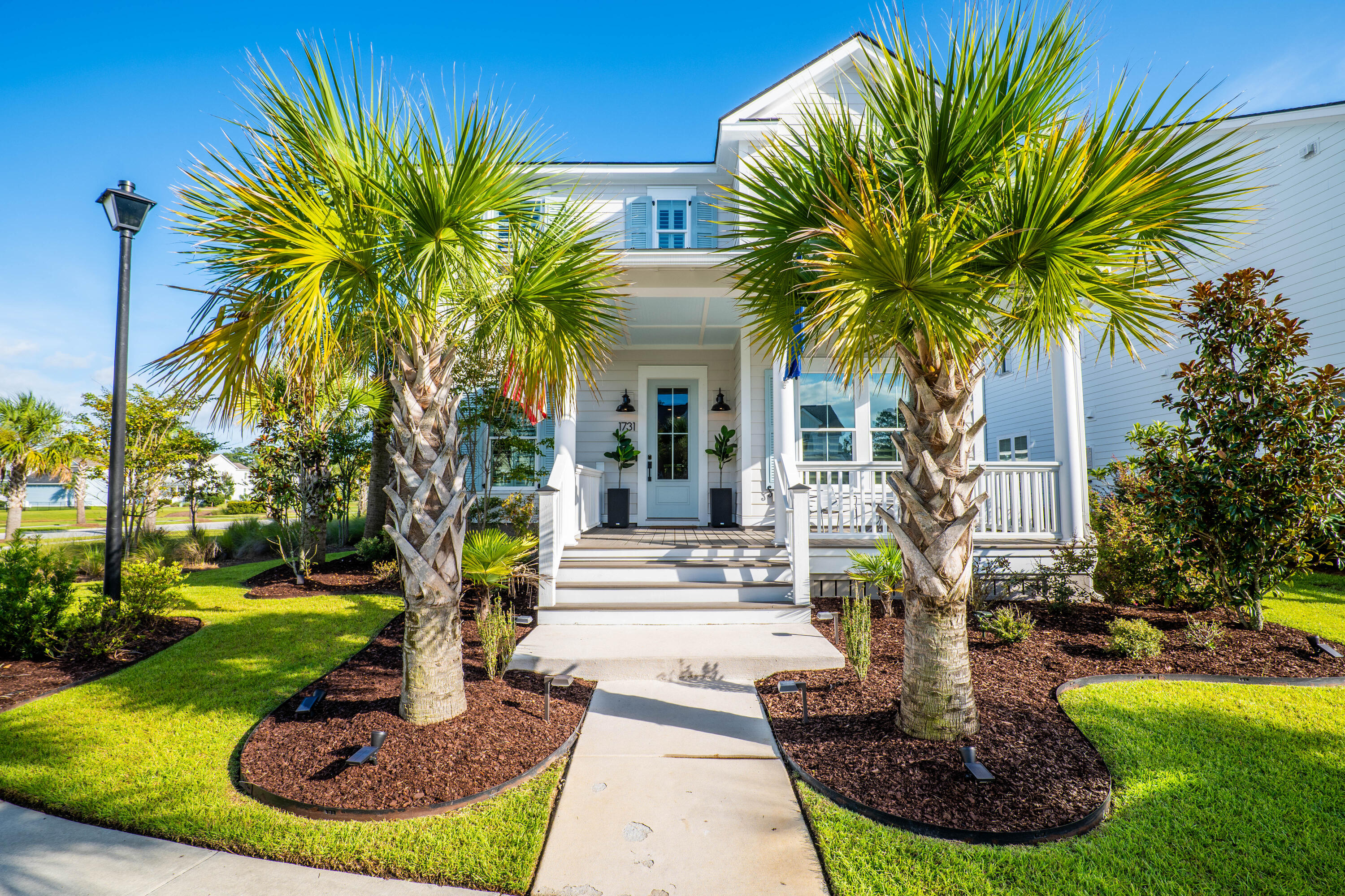 Nestled on a quiet, non-cut-through street in sought-after Carolina Park, this corner-lot home sets itself apart the moment you arrive. Pond views stretch around the property, giving the home an uncommon sense of privacy and calm. Mornings here begin with sunlight streaming into the primary suite and living room, carrying over the water and through the windows, a natural reminder of why Mount Pleasant living is so coveted. From the street, manicured palms and a welcoming front porch hint at the lifestyle within: stylish, functional, and tailored for both relaxation and entertaining. Step inside and the details speak for themselves. Custom trim, crown molding, and natural light frame the open layout. The kitchen is a true centerpiece, with quartz countertops, double-stacked ovens, a...built-in microwave, stainless steel hood, pot filler with marble herringbone backsplash, upgraded matte black hardware, and a hidden pantry/coffee station that doubles as extra storage. A modern trimmed wall defines the living room, anchored by a herringbone tile fireplace with shiplap surround. Plantation shutters, tinted windows, and curated Roman shades complete the aesthetic with polish and practicality.

Upstairs, the primary suite takes full advantage of the pond views, with morning light flooding the room and a walk-in closet that feels like its own retreat. A custom trim wall at the stairwell landing and built-in desk nook add thoughtful touches, while an office/guest suite with a full bath downstairs offers flexibility for visitors or work-from-home living.

Outside, the transformation is complete. A custom hardscape with hex pavers, river rock, a built-up grill space creates the ultimate backdrop for hosting, and an extended the driveway for extra parking. Fourteen palms define the space, complemented by a custom garbage/recycling enclosure and an HVAC hideaway that keeps the aesthetic clean. Load up the golf cart, and you're just minutes from dining, shops, and two neighborhood pools...all while knowing you'll come home to a backyard designed for peace.

From the garage storage racks to the vertical shiplap in kitchen, dining and pantry nook, every upgrade here adds both style and function. This isn't just a house with pond views, it's a home that blends Charleston charm with modern convenience, on one of the quietest streets in Carolina Park.