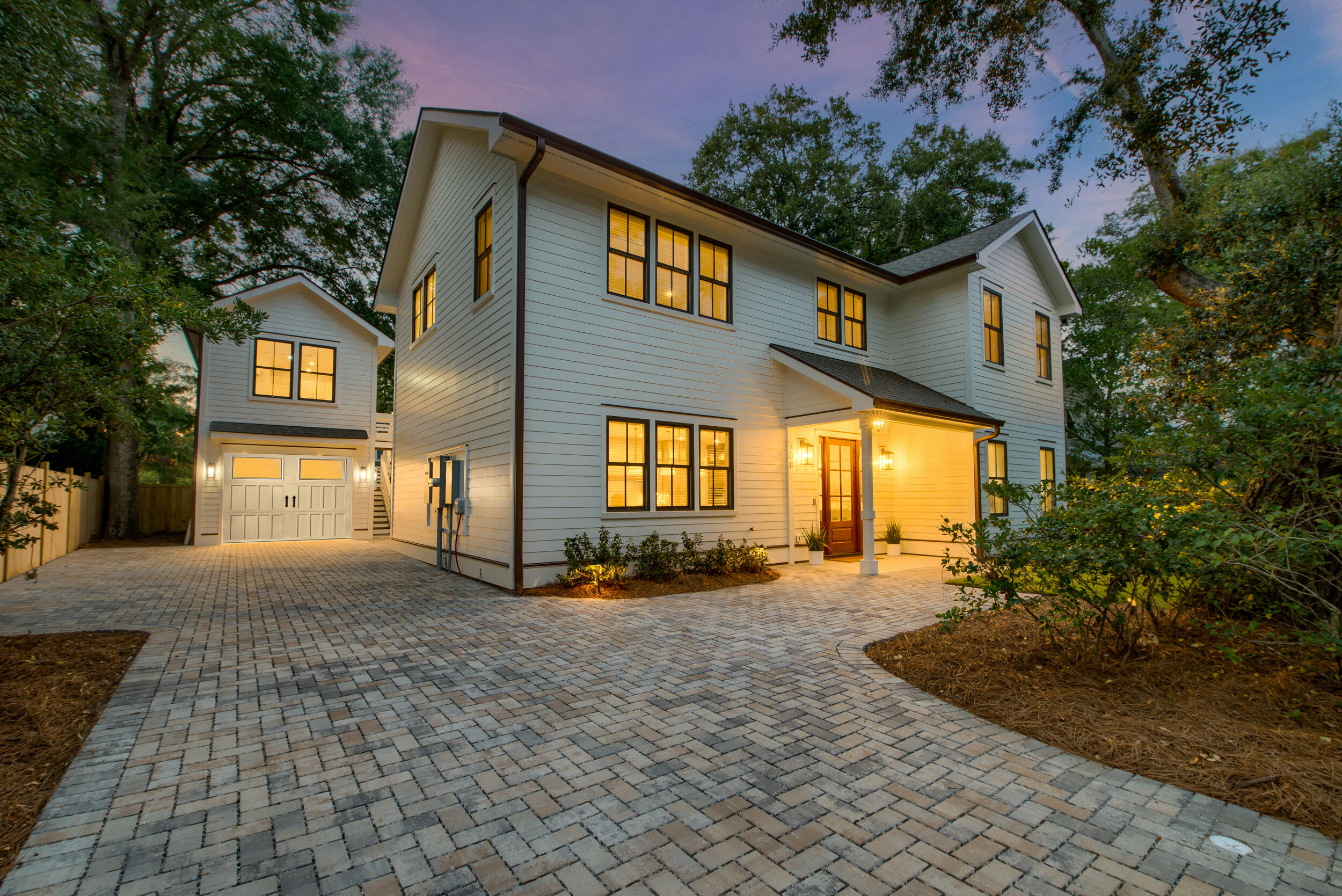 New Construction with Detached ADU in Old Village Area!Welcome to a brand-new home located in one of the most desirable areas of the Lowcountry. This stunning 2025 custom build offers luxury living just a short walk or bike ride from the charming shops and restaurants of the Old Village and Sullivan's Island.The exterior of the home blends classic coastal style with a fresh, modern feel. The professionally landscaped yard, complete with new sod, azaleas, and holly trees, provides beautiful curb appeal.Inside, you'll be greeted by an open, airy layout filled with natural light. Tall 10-foot ceilings and gorgeous 8-inch white oak hardwood floors flow throughout the main level.The heart of the home is a state-of-the-art kitchen, featuring a 42-inch Miele gas cooktop, a 42-inch KitchenAid side-by-side refrigerator, and a combination microwave/air fryer. The centerpiece is a dramatic 2.5-inch Taj Mahal quartzite island with waterfall edges. Custom floor to ceiling cabinetry and a 14-foot walk-through pantry with a wet bar connect to the covered back porch, creating a perfect space for entertaining.

The private primary suite is a true retreat. It includes a walk-in closet with custom cabinetry and a separate washer and dryer hookup. The spa-like ensuite bathroom features a wet room with both a soaking tub and a shower. A convenient powder room and mudroom are also on the main floor.

The second level boasts 9-foot ceilings and a spacious loft with a built-in dry bar, surround sound wiring and an accent wall. Four additional bedrooms are located upstairs, two with private ensuite baths and two with a shared hall bath. A second laundry room is also on this floor for convenience.

A detached one-car garage includes a separate, loft-style accessory dwelling unit (ADU). This 290 square-foot space features a kitchenette, a full bathroom, and a tankless hot water heater, making it ideal for guests, a home office, or a potential rental unit.*

Additional features include Sonos in-ceiling speakers on the main floor, surround sound wiring on the second level, and charming paver walkways. This exceptional property is a rare opportunity to own a meticulously designed home in an incredible location, offering the best of coastal Lowcountry living.

*The listing agent is related to the seller. 
*Rental potential is not guaranteed and requires approval from all governing bodies. 
*Some images have been AI-generated.