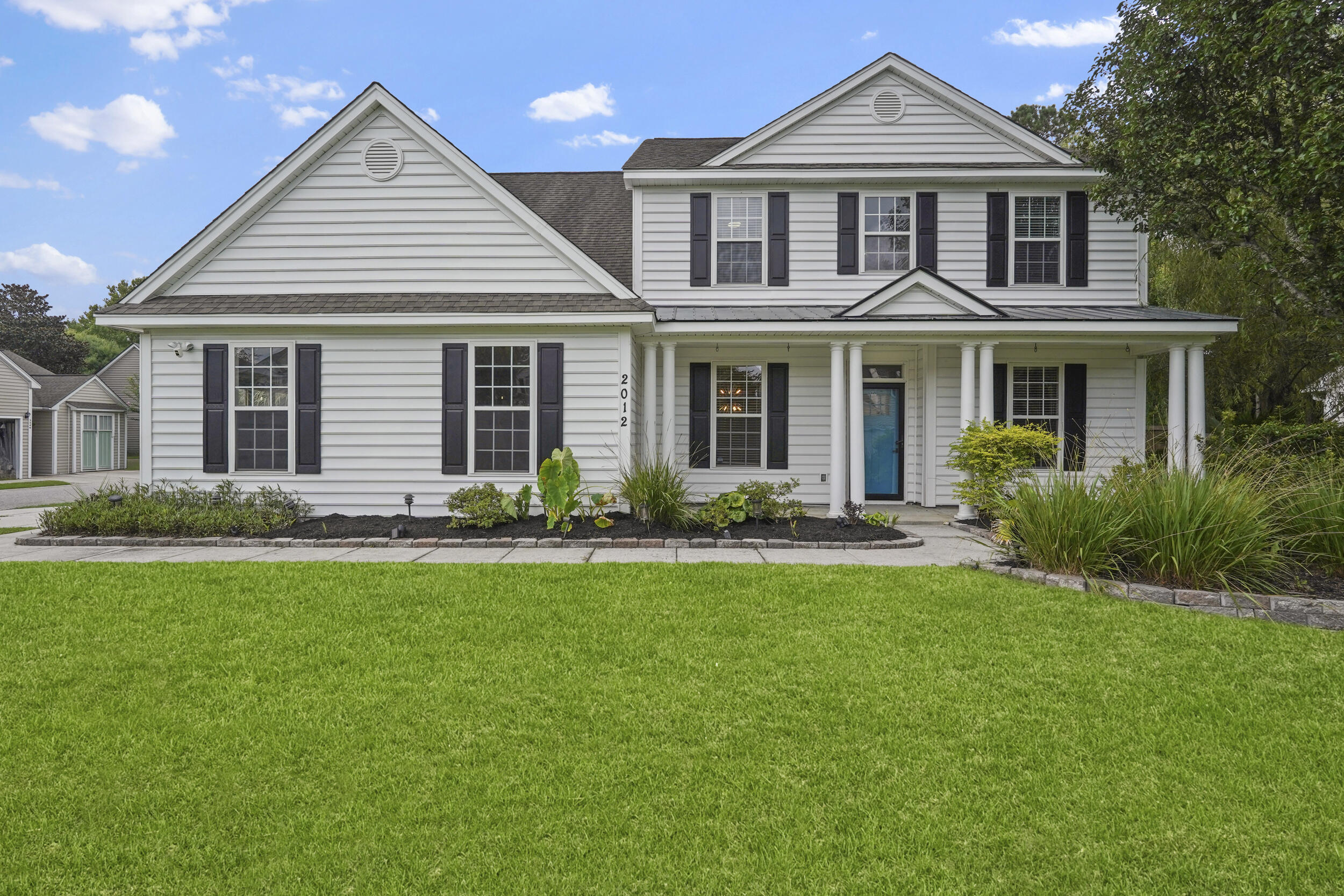 Welcome to 2012 Hammond Drive!  Tucked inside the sought-after Park West neighborhood, this thoughtfully updated coastal retreat sits on a large corner lot and blends style, comfort, and convenience all  just minutes from everything Mount Pleasant has to offer! From the moment you step inside, you're greeted by an abundance of natural light and a breezy open feel, further complimented by BRAND NEW hardwood floors throughout the main level!  A formal dining space sits to your left while a versatile sitting area welcomes you on the right, ideal for morning coffee or relaxed conversation. Moving into the heart of the home, the living room boasts soaring two-story ceilings, giving the space an airy, grand feel while maintaining its cozy charm thanks to the modern fireplace.The kitchen is a showstopper, featuring quartz countertops, a classic subway tile backsplash stainless steel appliances, and plenty of cabinetry for storage. Just off the kitchen, the sunlit eat-in nook offers picturesque views of the lush backyard and sparkling pool. The primary suite, conveniently located on the first floor, feels like a private escape. Enjoy a spa-inspired ensuite with a double farmhouse-style vanity, soaking tub, modern tile shower, and a generous walk-in closet with custom built-ins. Upstairs, you'll find a well-designed layout featuring three secondary bedrooms that share a full bath, plus an additional guest suite with its own private bath perfect for visitors or extended family. Step outside and you'll find yourself in your own tropical oasis.  Fruit trees including peach, pear, apricot, apple, banana, and kumquat dot the landscape, creating a garden-like setting. Lounge under the pergola on the trex deck, or take a refreshing dip in the heated pool surrounded by lush greenery. As an added bonus, the home has been treated with a thermal poly-ceramic coating to help regulate interior temperatures year-round and includes an irrigation system. Don't miss your chance to enjoy the best of Lowcountry living in this beautifully upgraded home. Schedule your tour today!