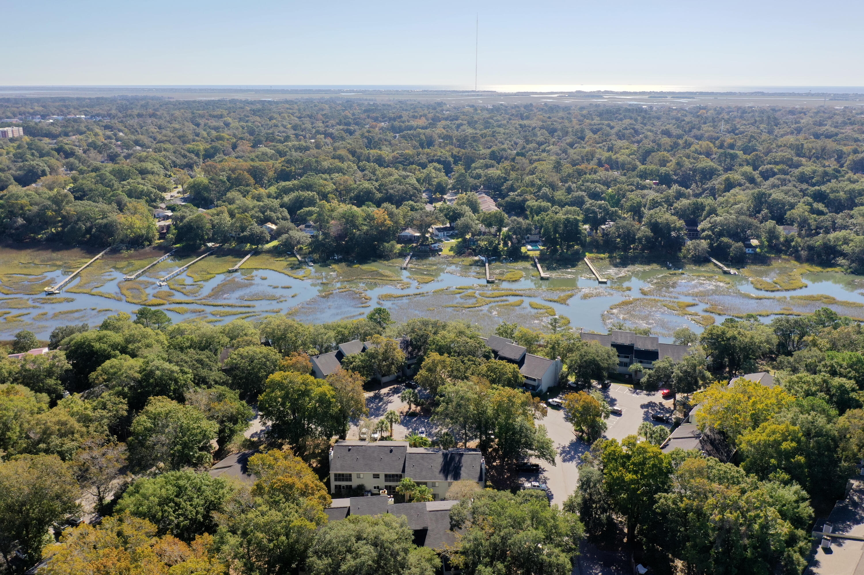 Located in the heart of desirable South Mount Pleasant, this first floor, one level townhome is bright, airy and move-in ready! Ideal for a primary residence close to all the conveniences of town, including grocery stores, shopping, entertainment and recreation. Or enjoy this turn-key condo for a vacation home less than 15 minutes from the Beach and Downtown Charleston. Hop on 526/26 nearby to make your travel in and out of town a breeze. Even the airport is less than 30 minutes away. Inside, the sunlit interior offers a nice living room with brick wood-burning fireplace and adjacent screened porch. The kitchen has nice storage, a pantry and a separate dining area.A hallway with laundry closet leads to the primary en suite and a second bedroom with nicely updated hall bath. Both bedrooms access an enclosed rear patio ideal for a seating area, small herb garden, kayak storage and more. Take a short stroll to the community dock on Shem Creek to enjoy the gorgeous Lowcountry sunsets. Also close by is the community pool with picnic shelter - perfect for those lazy summer days. Come see this great townhome today!