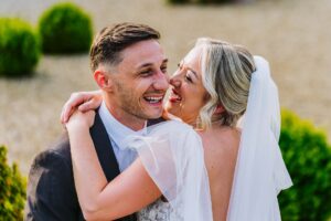 Bride and Groom hugging on heir wedding day at Wasing Park Barns