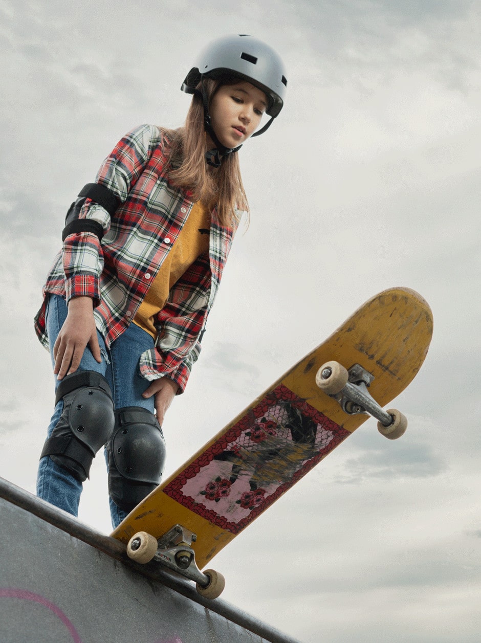 white skater girl dropping into a half pipe