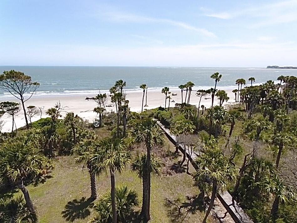 Exquisite oceanfront home on the private island of Dewees, boasting more than 1200 acres of undisturbed sandy beaches.  Imagine an opportunity to set back in time where homes were surrounded by lush mature landscaping and all you heard on the beach were the waves crashing and the seagulls singing.  Welcome to Dewees, a place steeped in rich history where residents travel by golf cart, eagles nest and large crowds are unheard of.  Modern conveniences make living here easy with companies shipping groceries and supplies right to the island.  This is truly a special home with an outstanding floor plan perfect for every day living or the perfect vacation destination.  A small wooden bridge driveway leads you to the home where you will first notice the beautiful structure blending with nature.The three story home has a ground floor, completely screened-in, with a dining area, bike and golf cart storage, utility sink and tool room, elevator access, ping pong table, hammock and more.  There is also access to a deck which leads you down a semi-private walk shared by one neighbor to access the ocean.  The great backyard is private with natural plants and palm trees.  When you get to the sand, other people are a rare sighting, but what you will see is miles of waterfront covered in sand and driftwood.  Back at the house, the elevator takes you to all three living floors.  To maximize the views, the main living areas are located on the second floor and owner's suite on the third floor, while the secondary bedrooms are on the first floor.  When you exit the wood floored staircase or elevator to the second floor you will be in awe of the open living space that provides uninhibited views of the ocean for miles out to sea.  This level includes full-open doors to the huge screened-in porch for the perfect spot to entertain or just enjoy time reading a book while the salt air breezes by.  You will also find a large living room with a fireplace open to a gourmet kitchen which features a $30,000+ Aga range, copper-style vent, recessed sub-zero refrigerator, eat-at island in soapstone, multiple Miele dishwashers, butler's pantry with built-in cabinetry, sink and dishwasher and so much more.  Two-semi-open rooms on the second floor could be an office, second living room and guest spaces.  Take the wood staircase or elevator to the third story will you will find a complete owner's suite with a private balcony, reading nook, private living room which is also a 5th bedroom, walk-in closets with built-ins, plus a double sink vanity, walk-in shower, soaking tub and coffee bar.  On the first floor, you will discover three bedrooms and three full bathrooms.  This level boasts another owner's suite with a walk-in shower, huge vanity and great views.  Another owner's suite features a tub/shower combo and all three bedrooms have outside access to a large screened-in porch on this level with a swinging bed.  The laundry room also has a utility sink and plenty of built-ins for storage.  A utility closet has a freezer and access to the mechanicals of the home.  All furnishings are included as part of the sale so all you have to do is pack your clothes and enjoy.  There is a generator to keep the power on if loss of power occurs.  The island is part of Charleston County and has a helicopter landing pad for emergencies, a post office, soccer/playing field, private pool and amenities center, plenty of fishing ponds, and an opportunity to experience untouched nature up close.  Buyer to verify anything deemed important.  It is recommended you discover island life through the website for Dewees Island.  Dewees Island POA's fiscal year runs from October and the Annual Operating Assessment and the Annual Reserve Assessment should be verified per the Dewees Island POA. All Sales for Dewees Island homes carries a Buyer-paid ¾% assessment of the total sales price to the ERB reserve by the buyer and a ¾% assessment of the total sales price to the ERB reserve by the seller.  Compare the prices of homes of this caliber on other beaches and you will love you came to see what Dewees Island can offer.