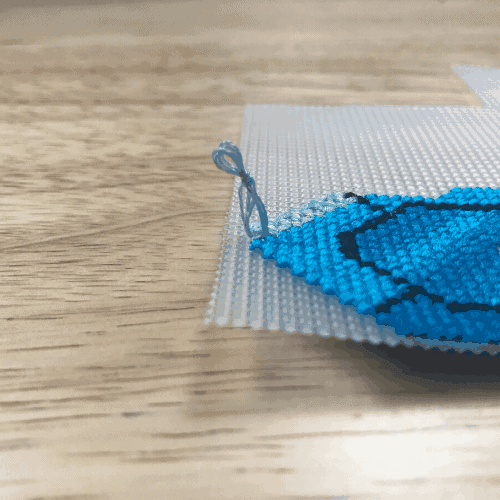 Blue embroidery thread in a knot that formed a loop.