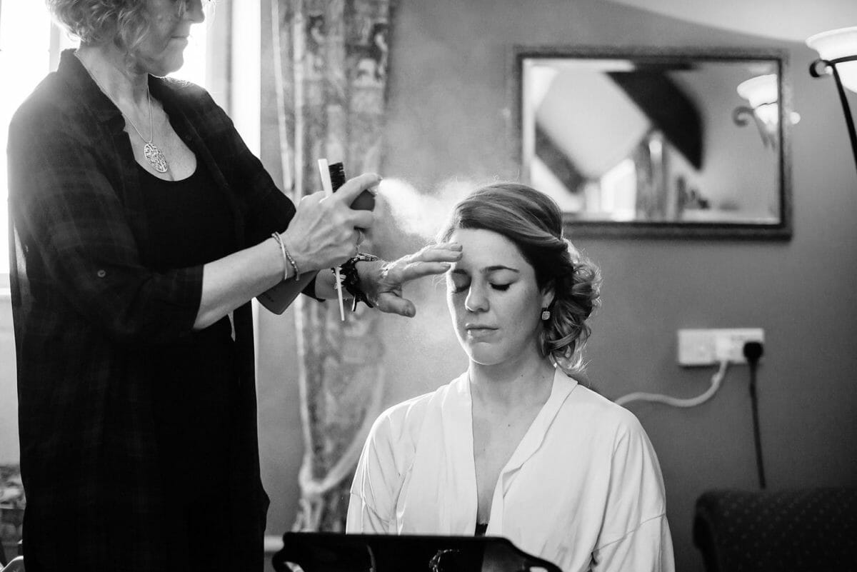 Bride having her hair sprayed