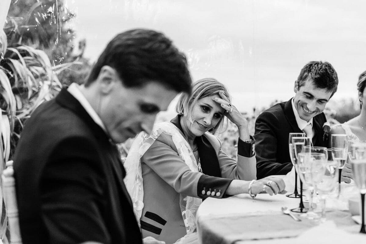 Mother of the bride holds her head at the speeches