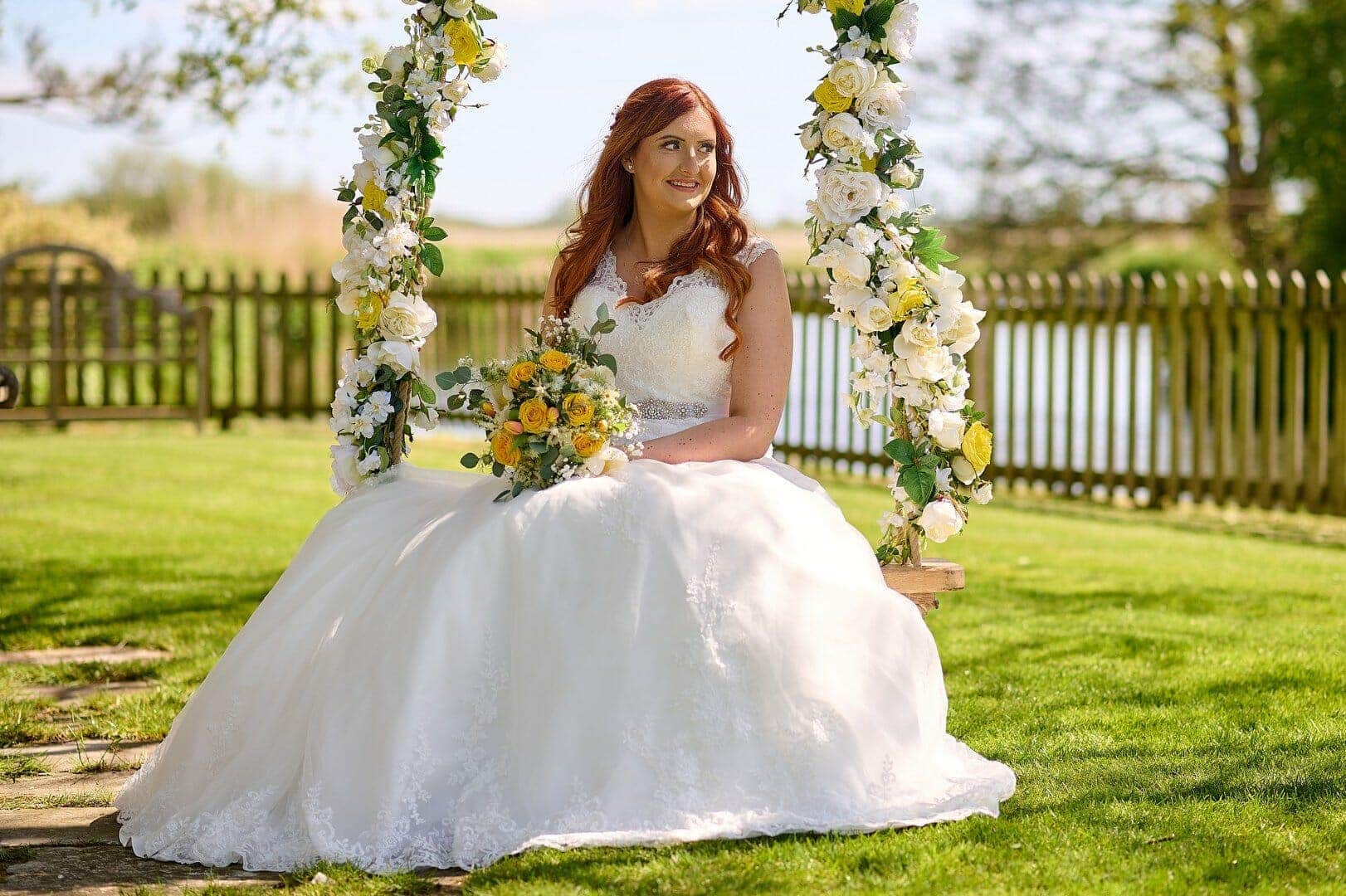 Bride swings on the rope swing at Sopley Mill wedding venue