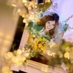 Sopley Mill Wedding- Bride by the stairs looking through a string of lights