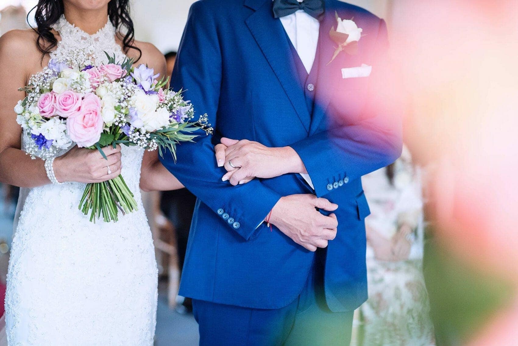 Grom holds brides hand in Wedding ceremony