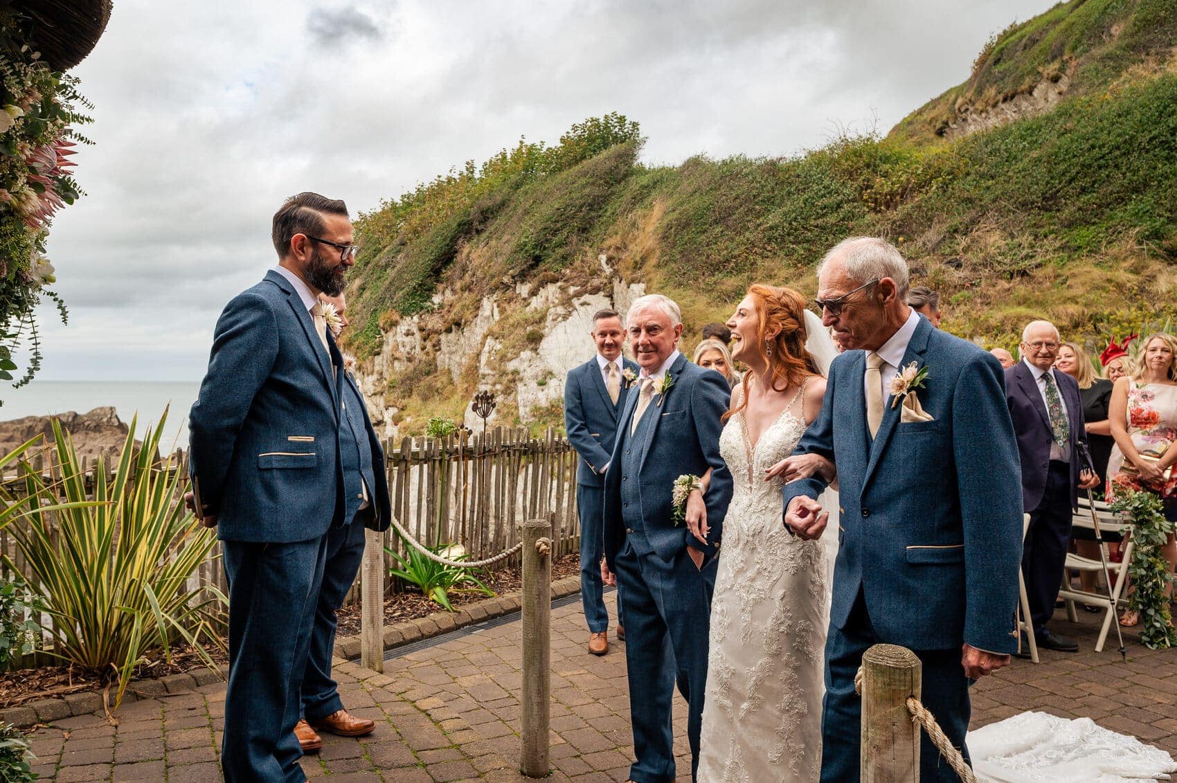 Happy bride laughes with the groom at Tunnels Beaches Wedding ceremony