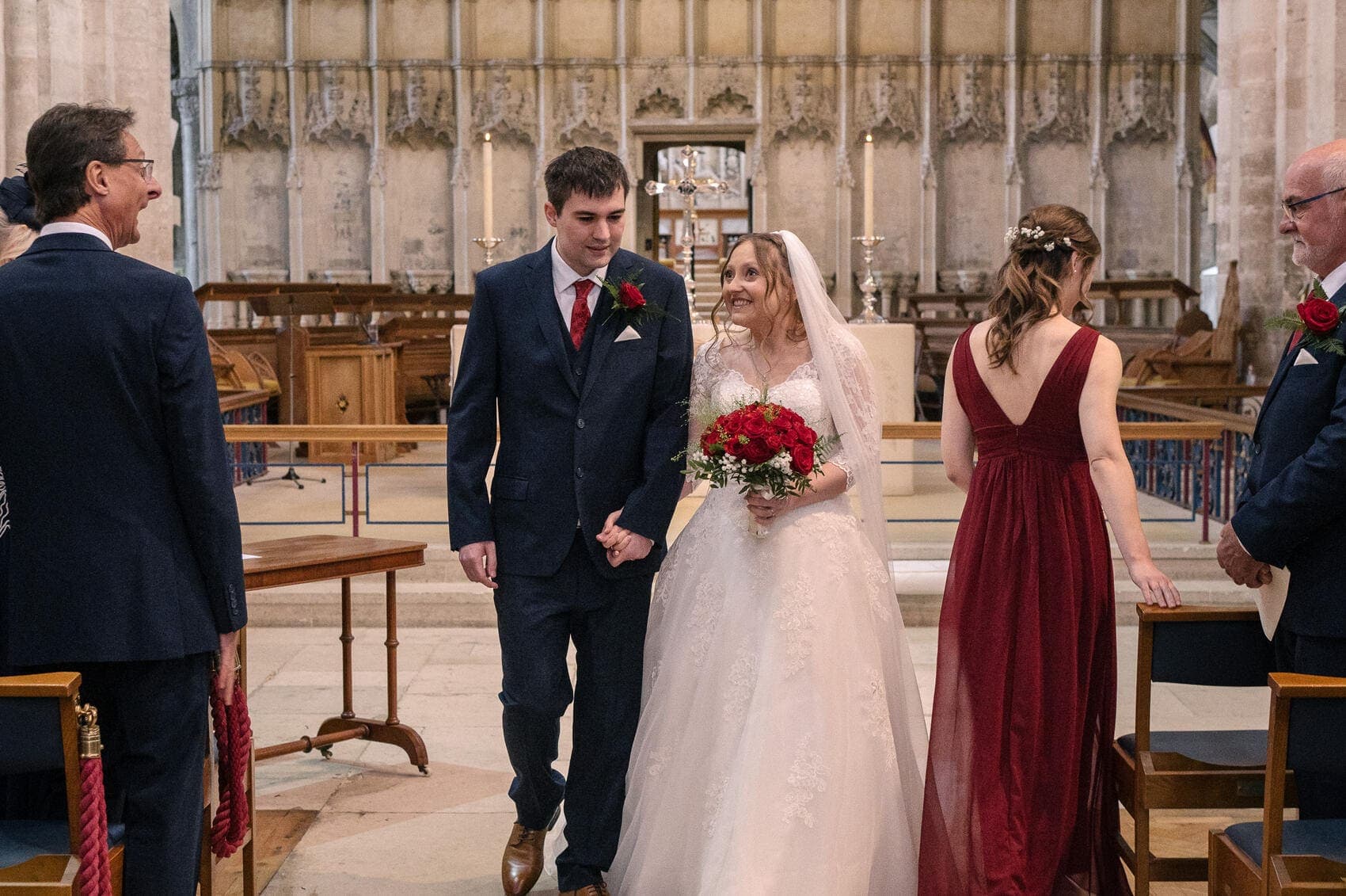 Bride and groom exit Christchurch Priory wedding ceremony