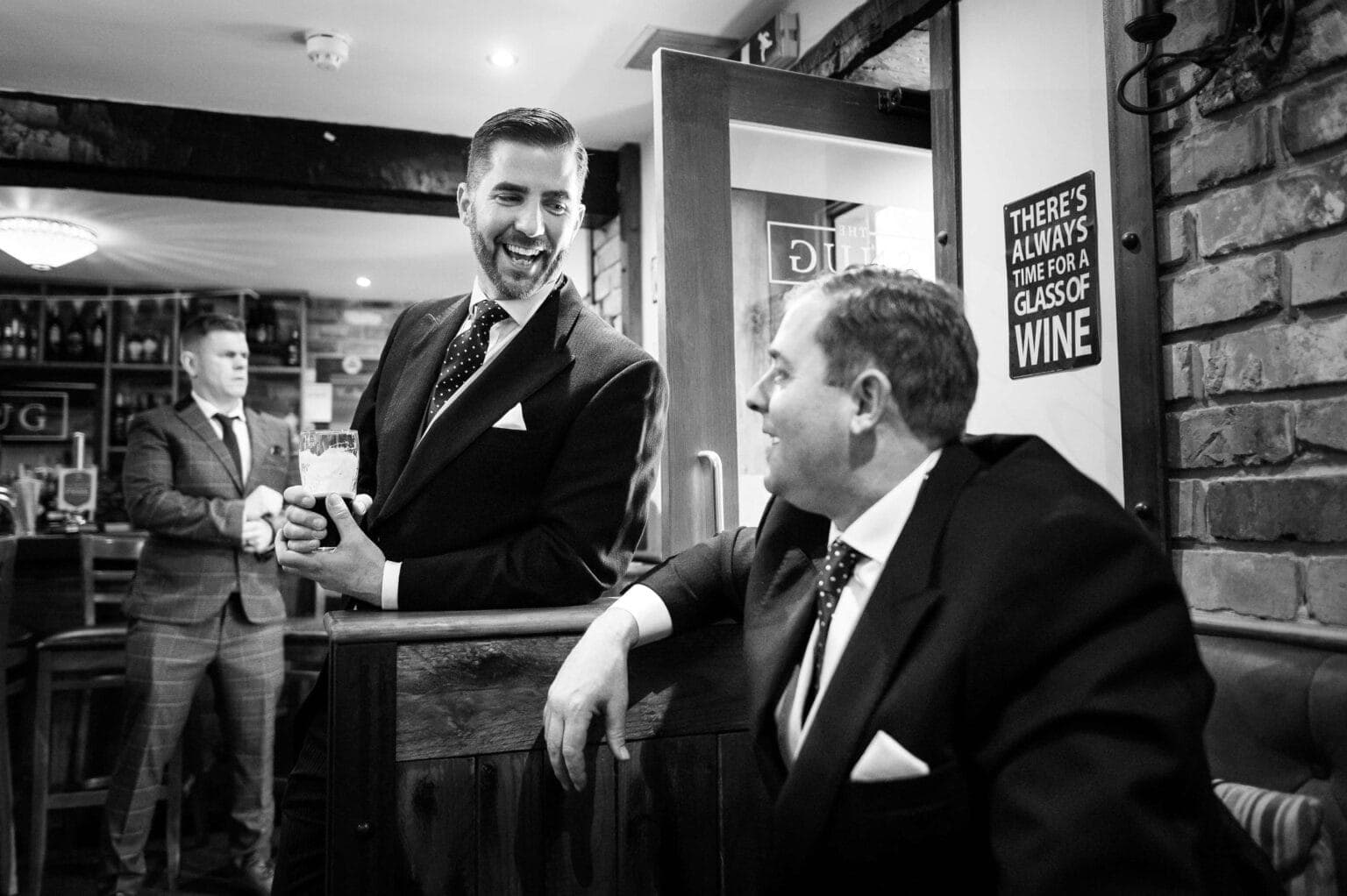 The groom laughing with the groomsmen