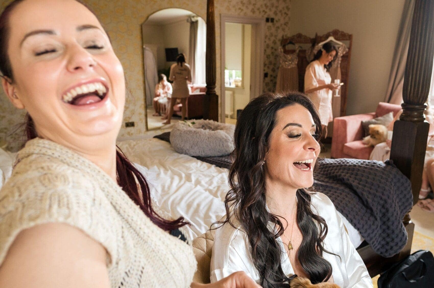 Make up artist and bride laughing