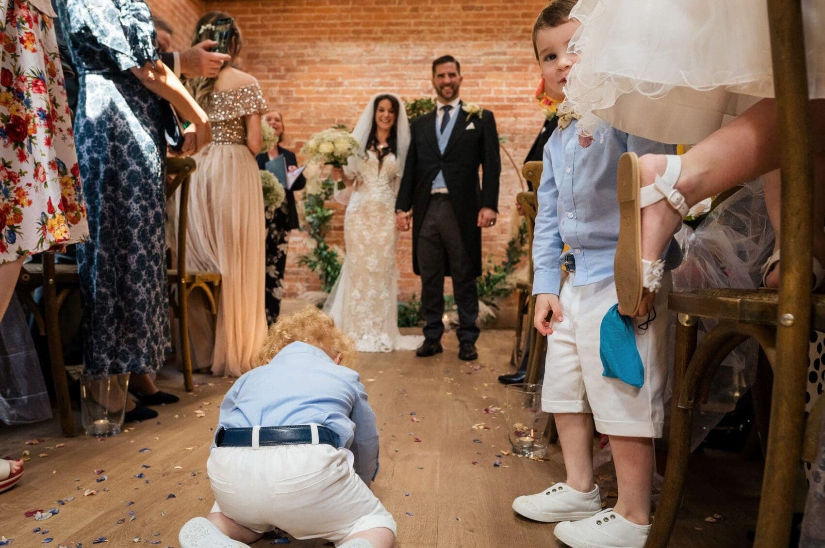 Pageboy laying in the aisle at Abbots Court wedding barn