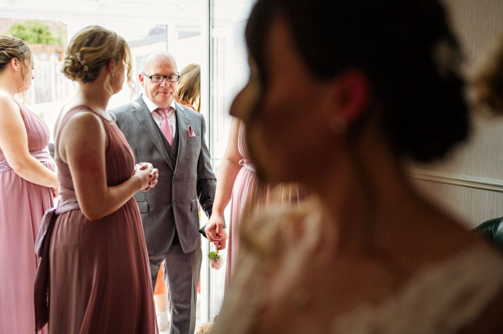 Father of the bride watches his daughter before St Mary's Catholic Church wedding