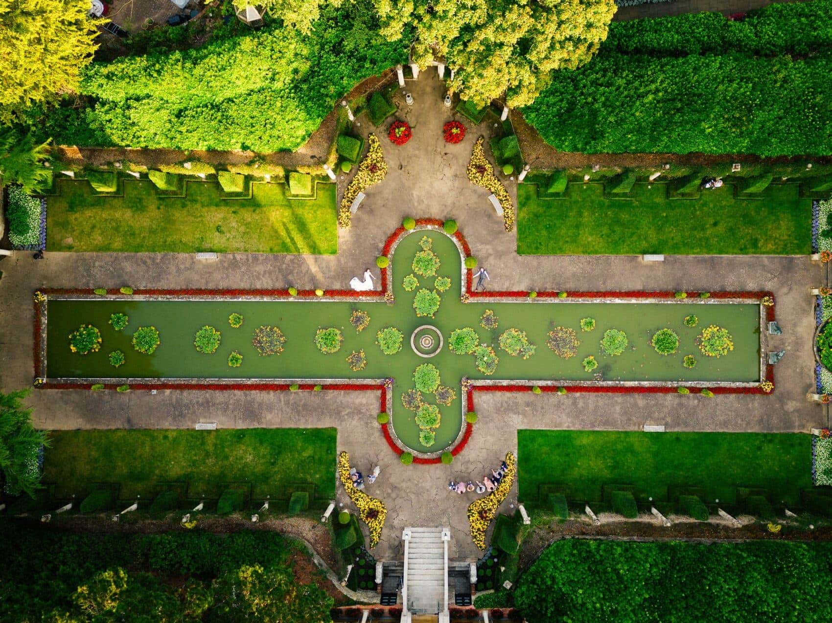 Drone photo of the pond at The Italian Villa in Poole with bride and groom