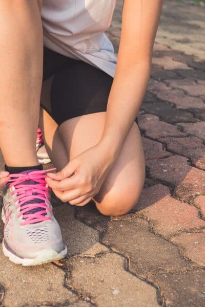 Woman tying running shoes